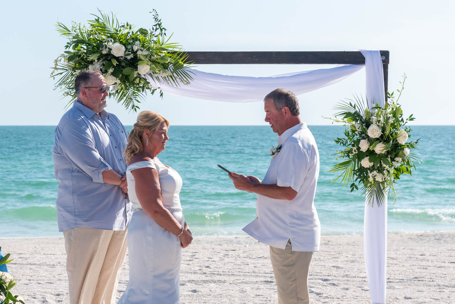 groom saying vows to his bride at the altar