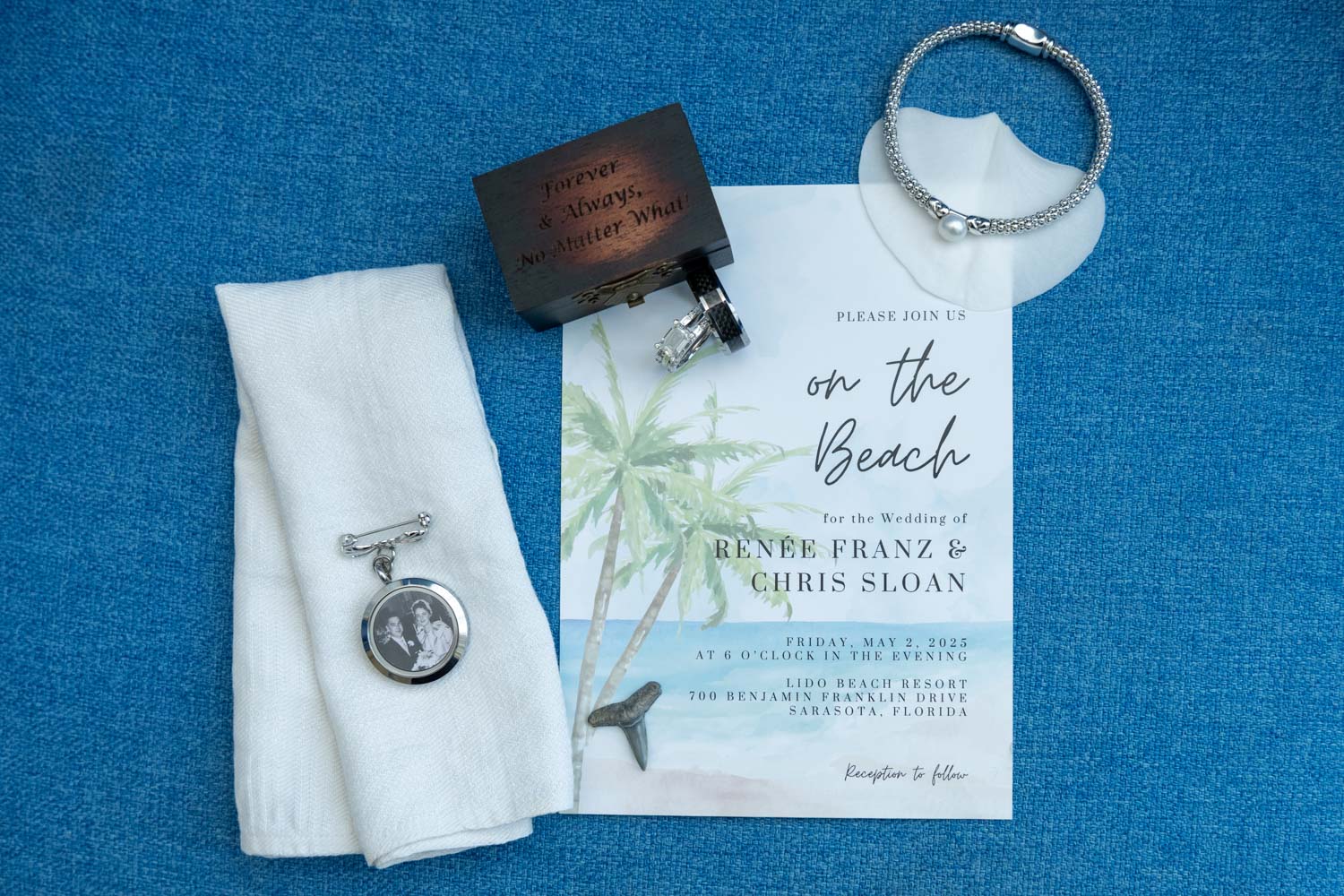 details for their wedding day including the invitation, rings, and locket