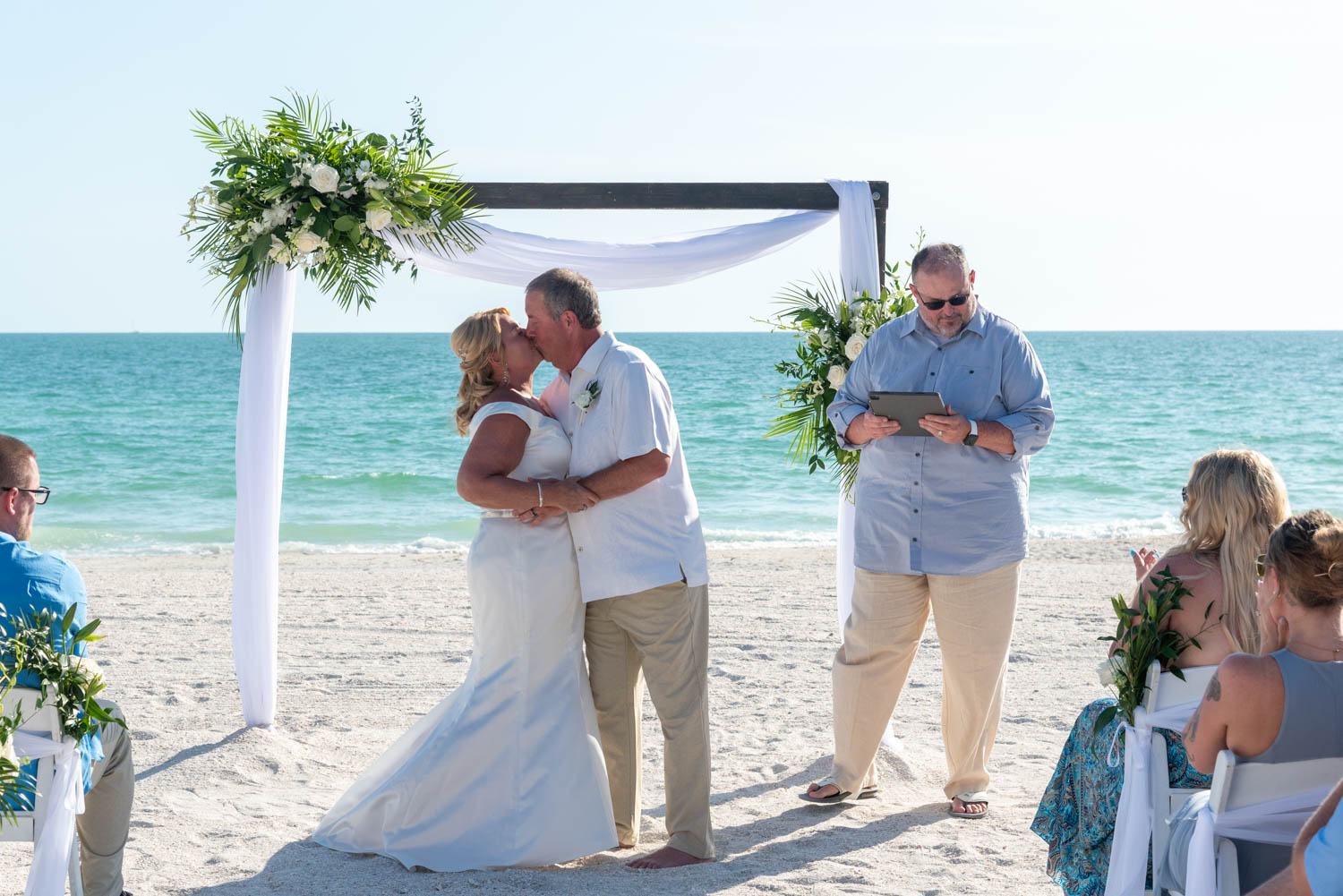 bride and groom share first kiss after ceremony on Lido Beach