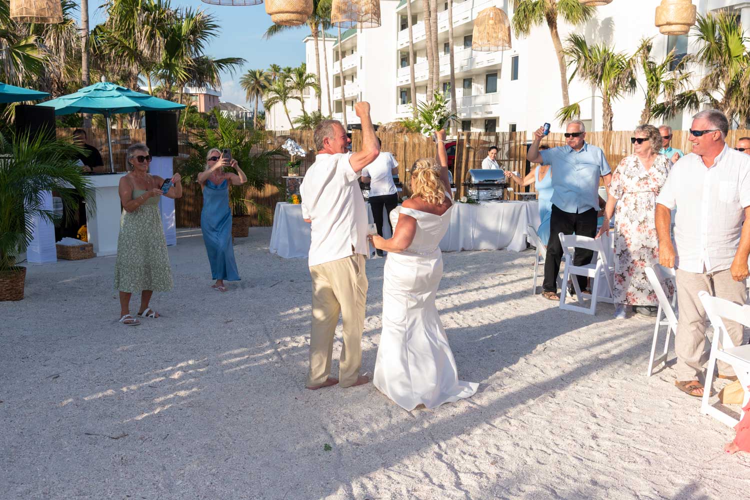 bride and groom cheer with their guests as they make their grand entrance into their reception