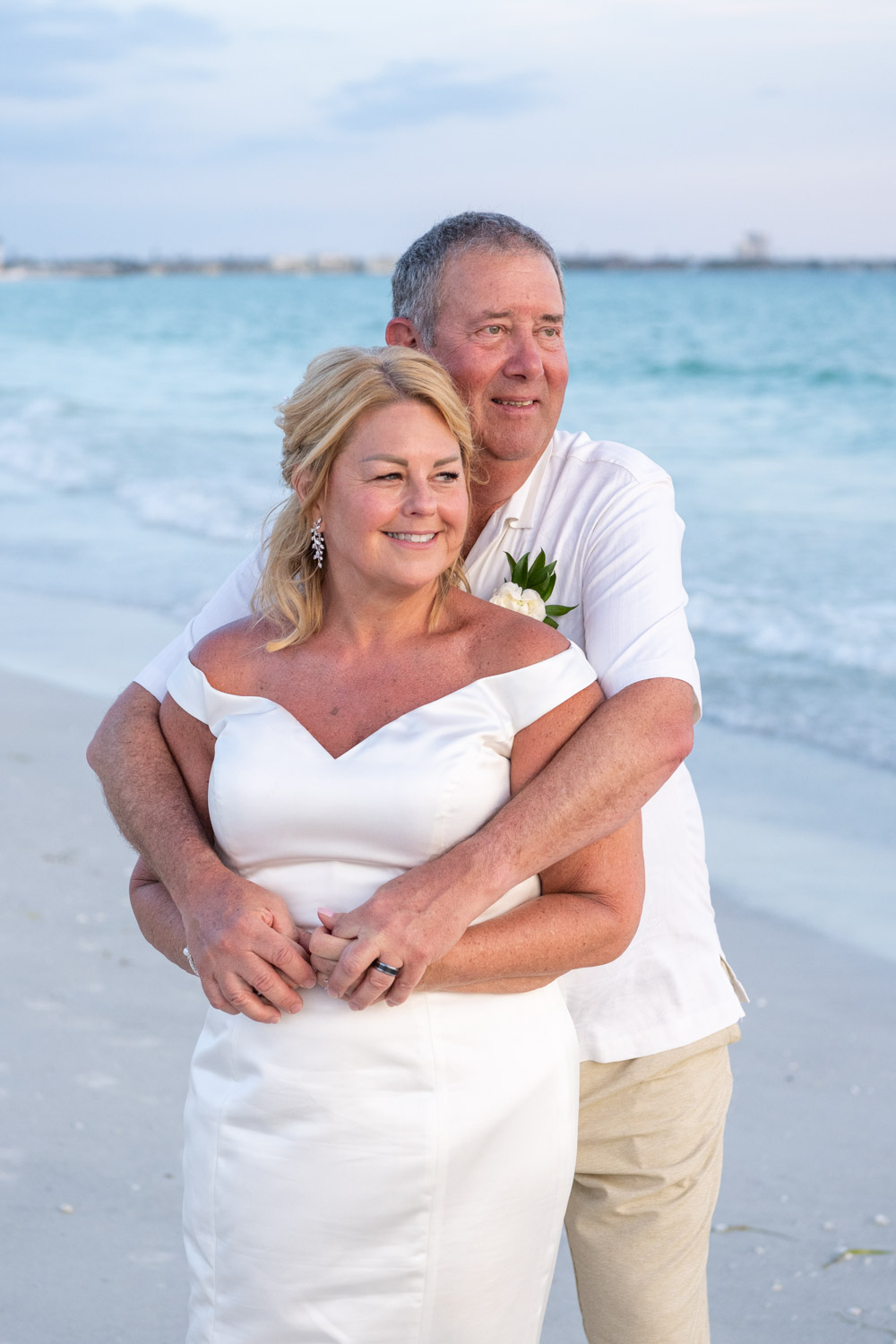 bride and groom look off into the distance on Lido Beach