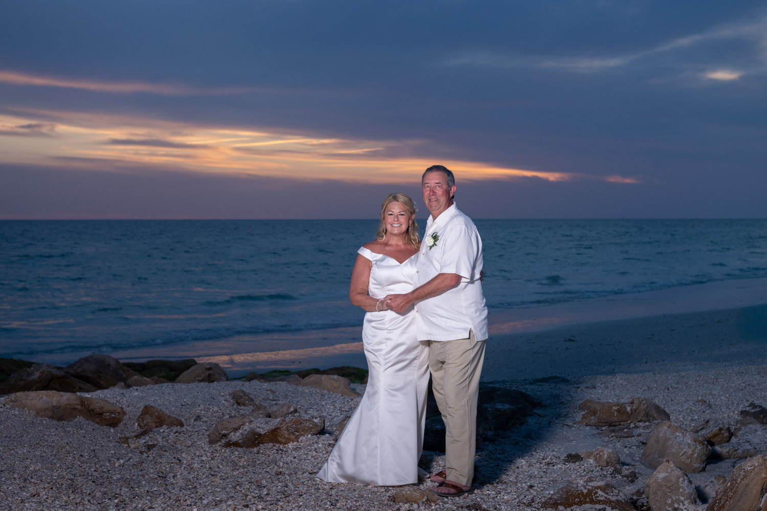bride and groom smile during wedding photos on Lido Beach