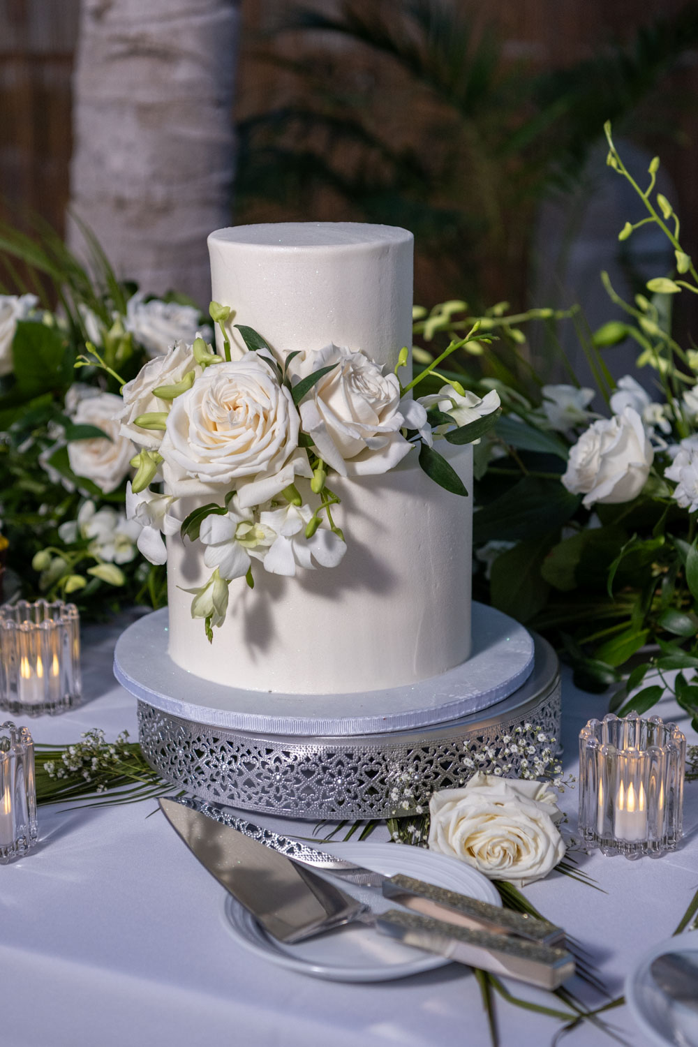 two tiered white wedding cake with white flowers by Cakes by Ron in Sarasota