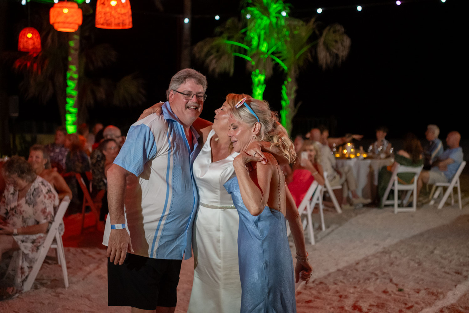 bride dances with her brother and sister during reception