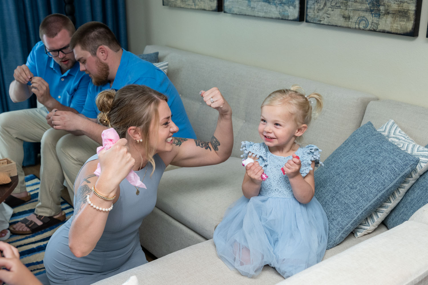 little girl and aunt making a strong pose with their arms and giggling
