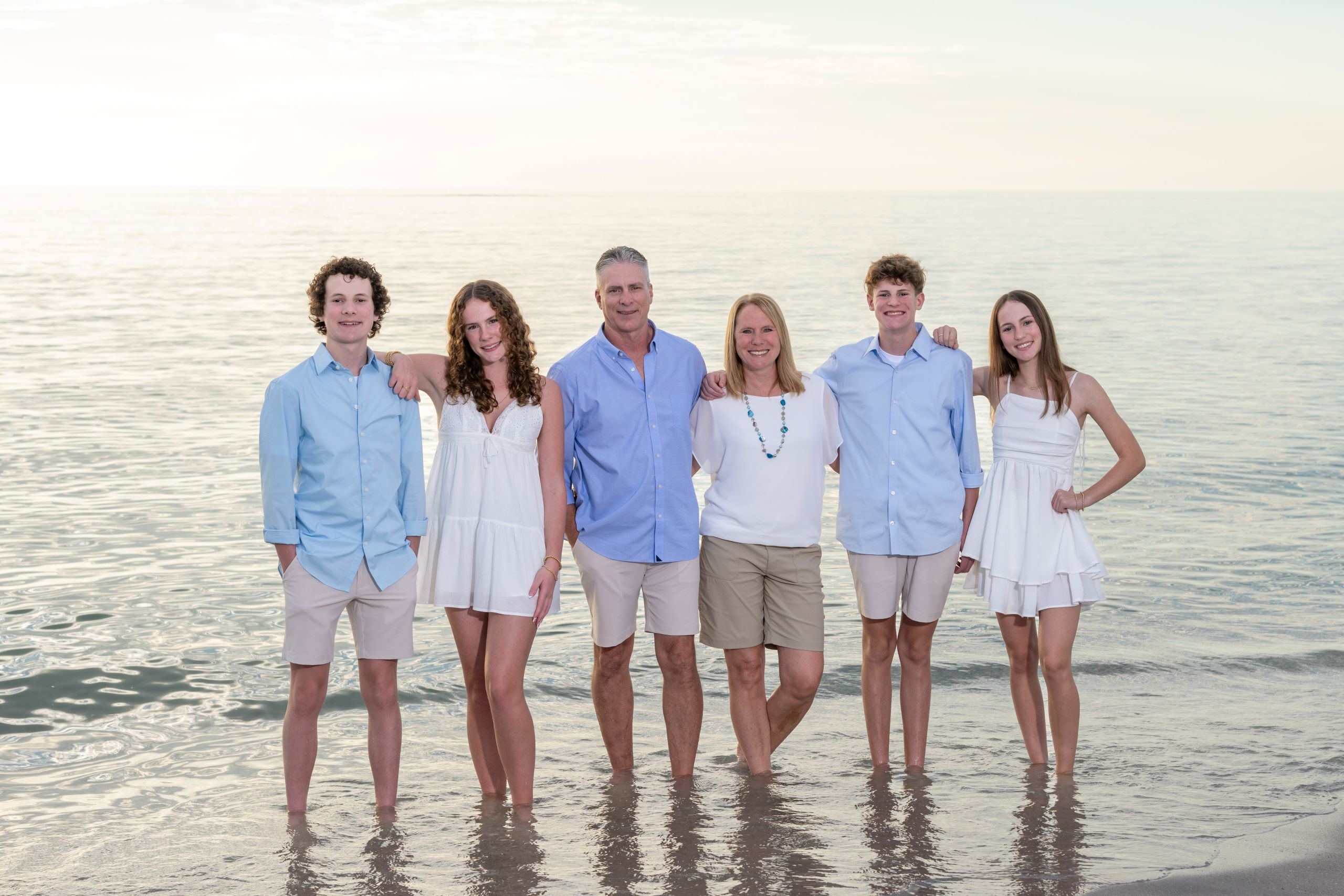 family standing in the water