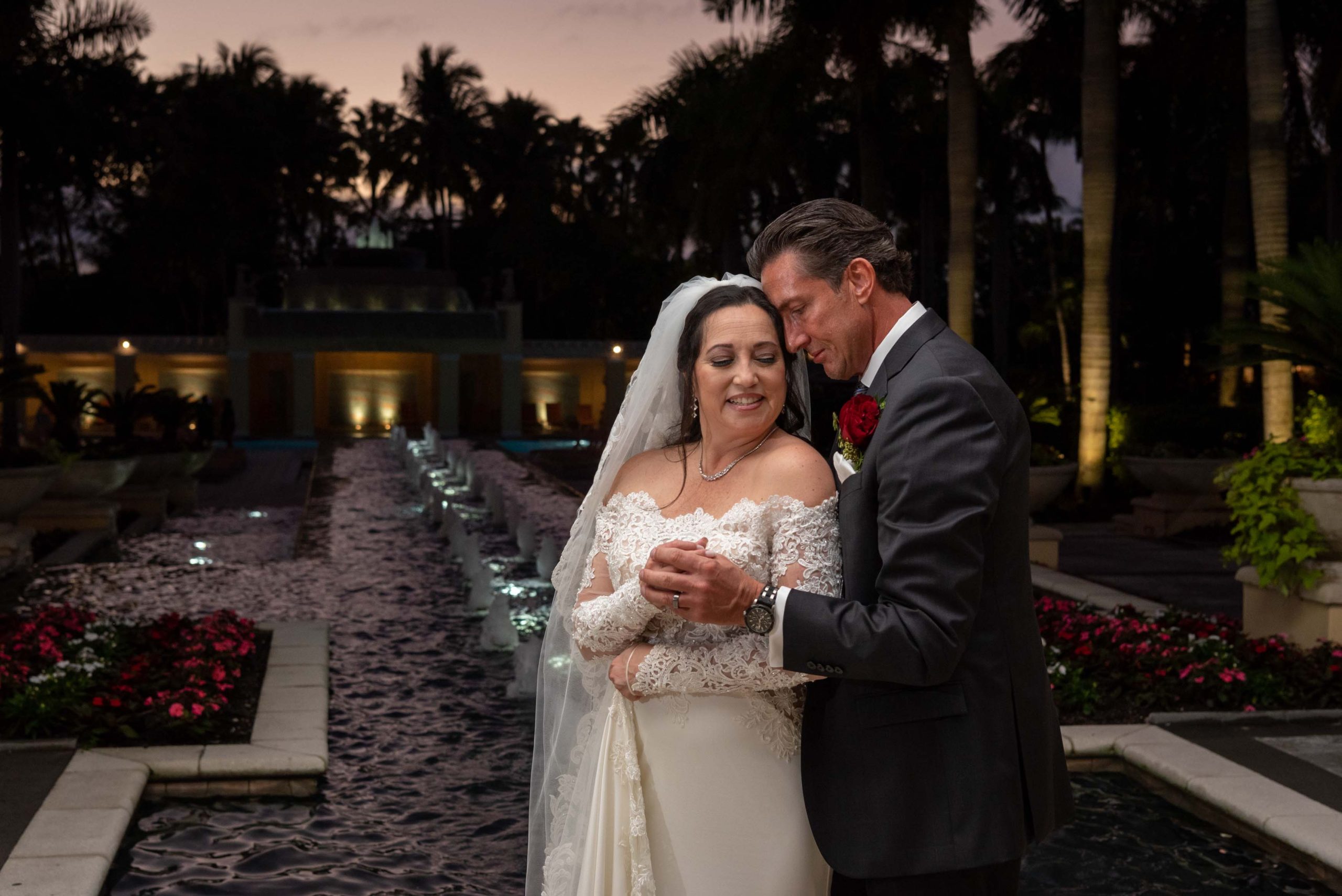 husband holds bride close as they get ready for their reception