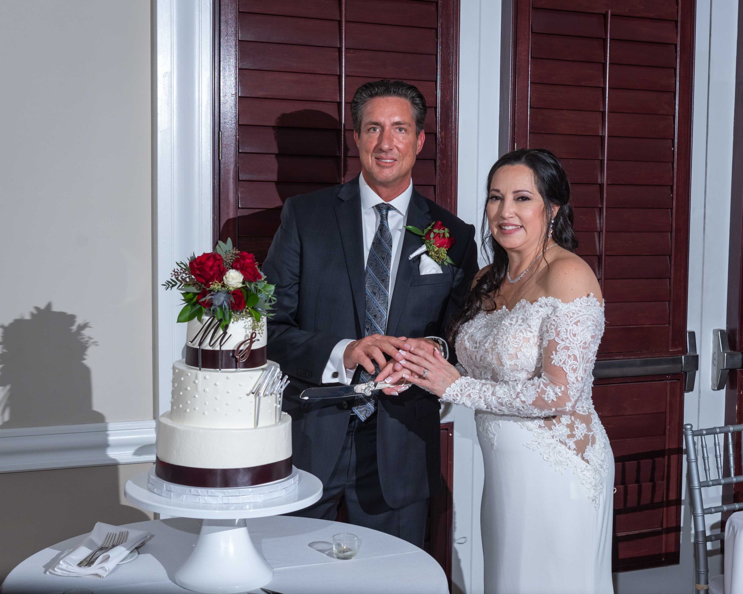bride and groom get ready to cut their wedding cake