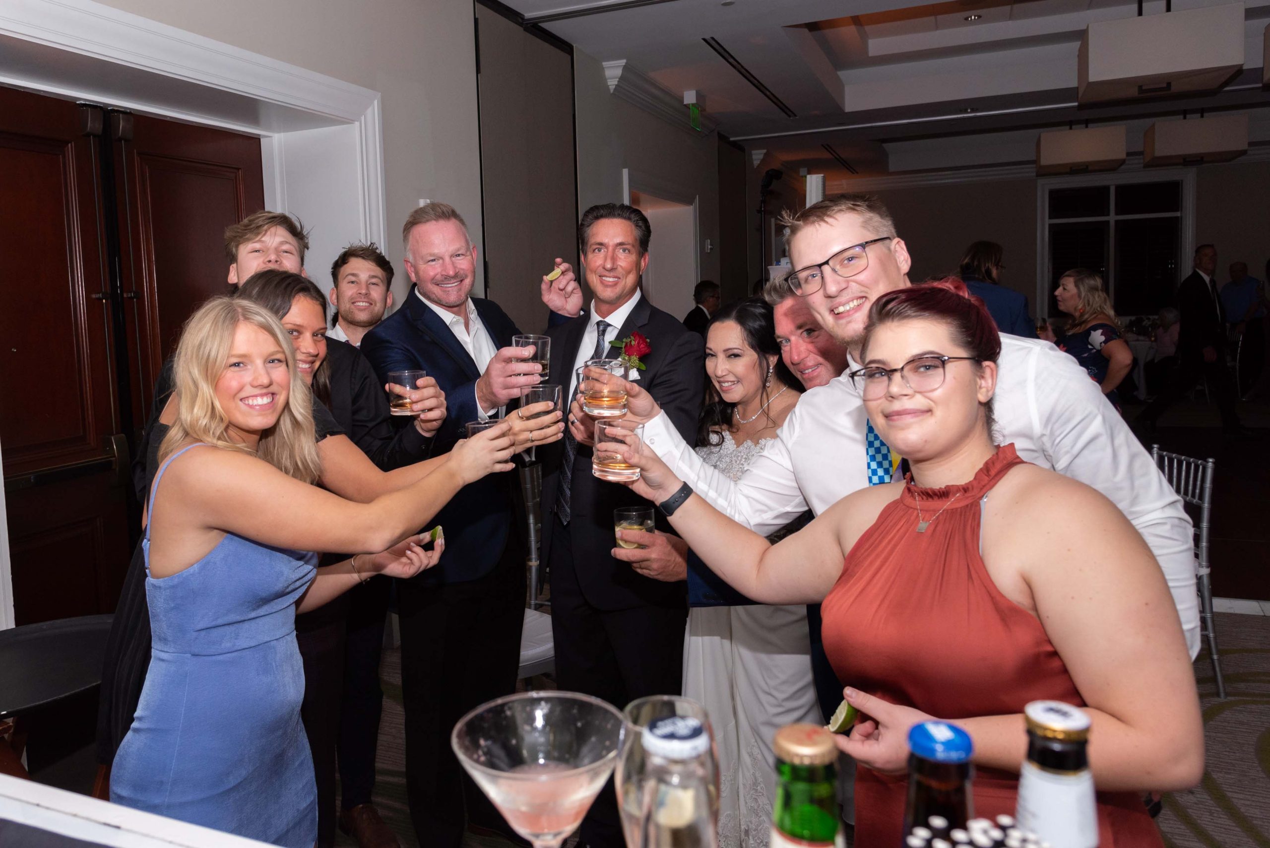 guests come together at the bar to toast the bride and groom