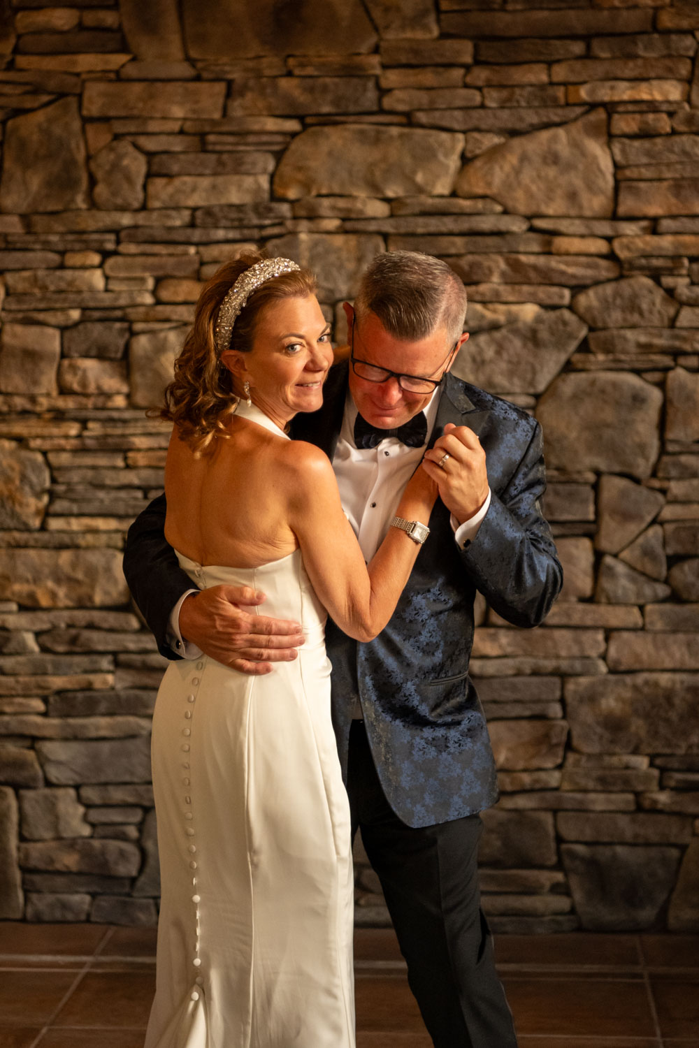 bride smiles as she dances with her husband