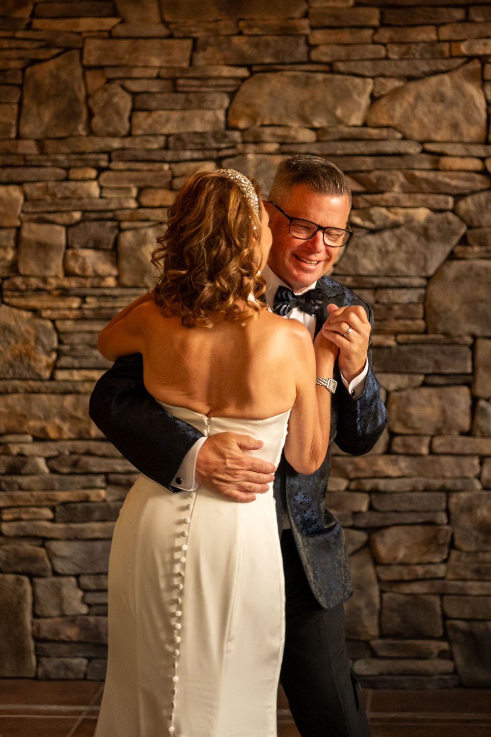 groom holds bride on the dance floor