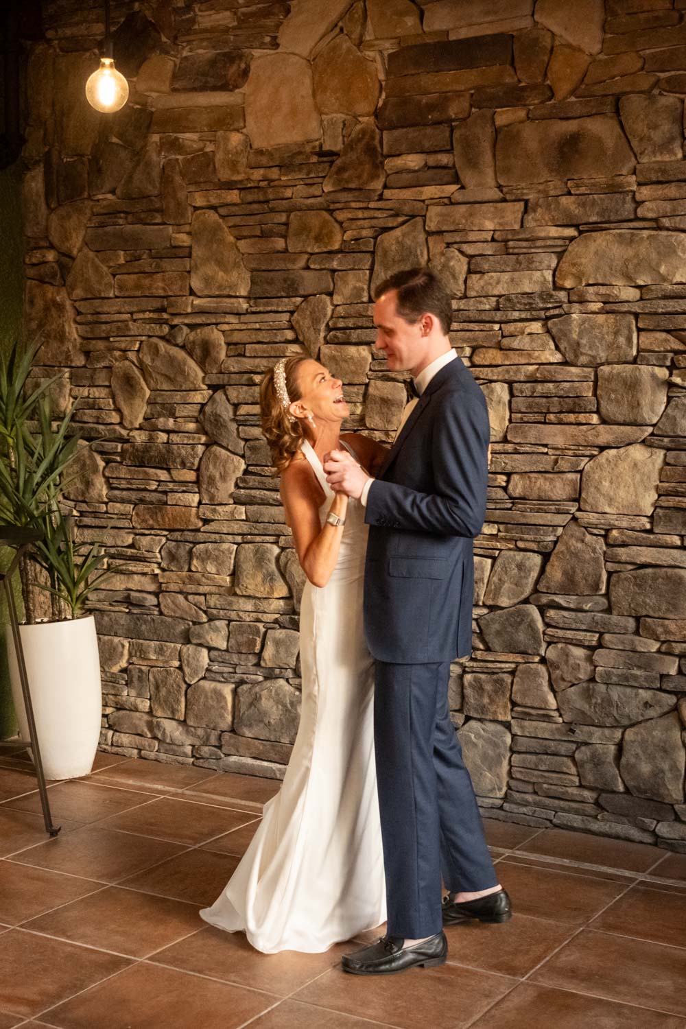 bride sings and looks up to her son as they dance