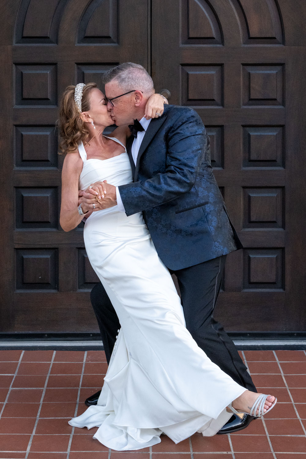 bride and groom share a kiss as he dips her