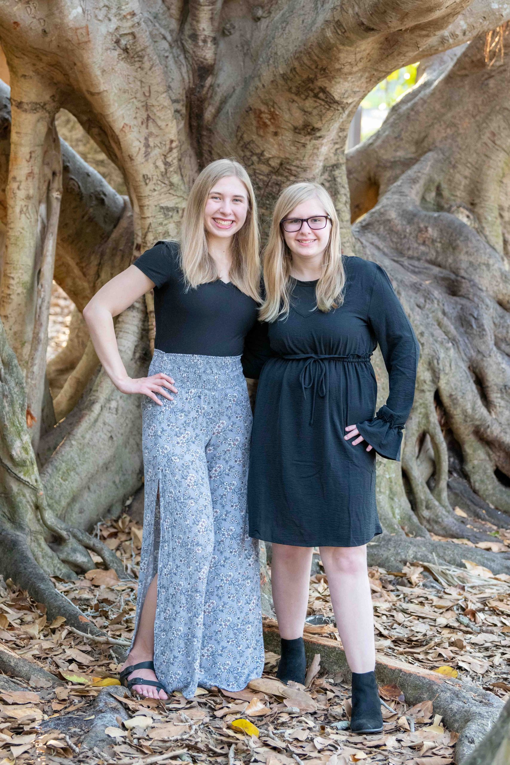 sisters in front of a banyan tree