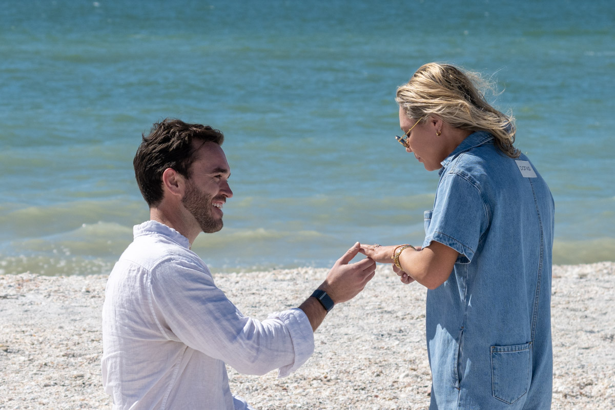 man touches ring to girls finger