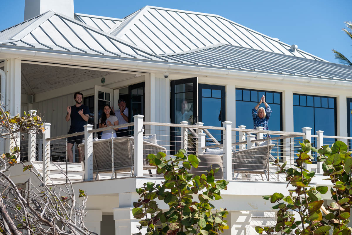 family comes out from inside house and cheer at the proposal