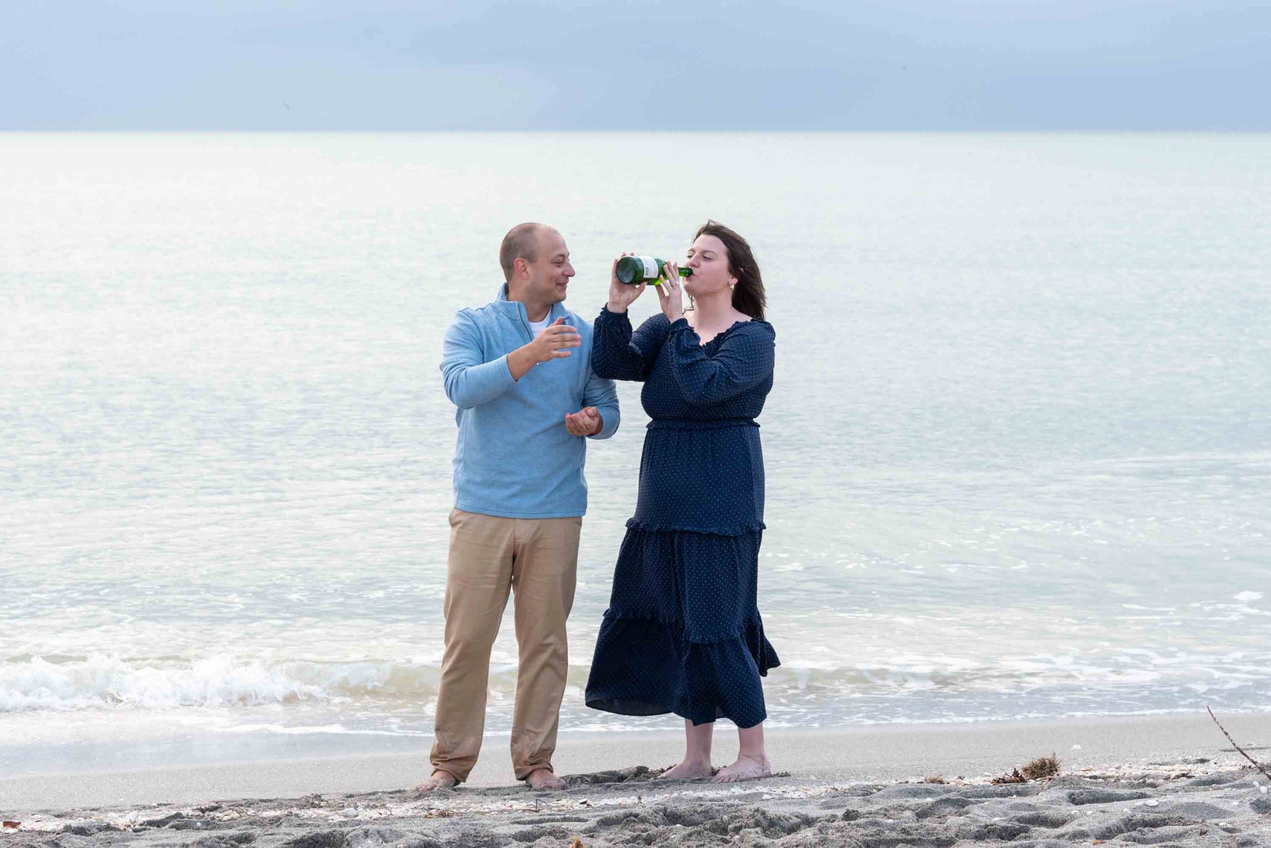 girl drinks directly from the champagne bottle