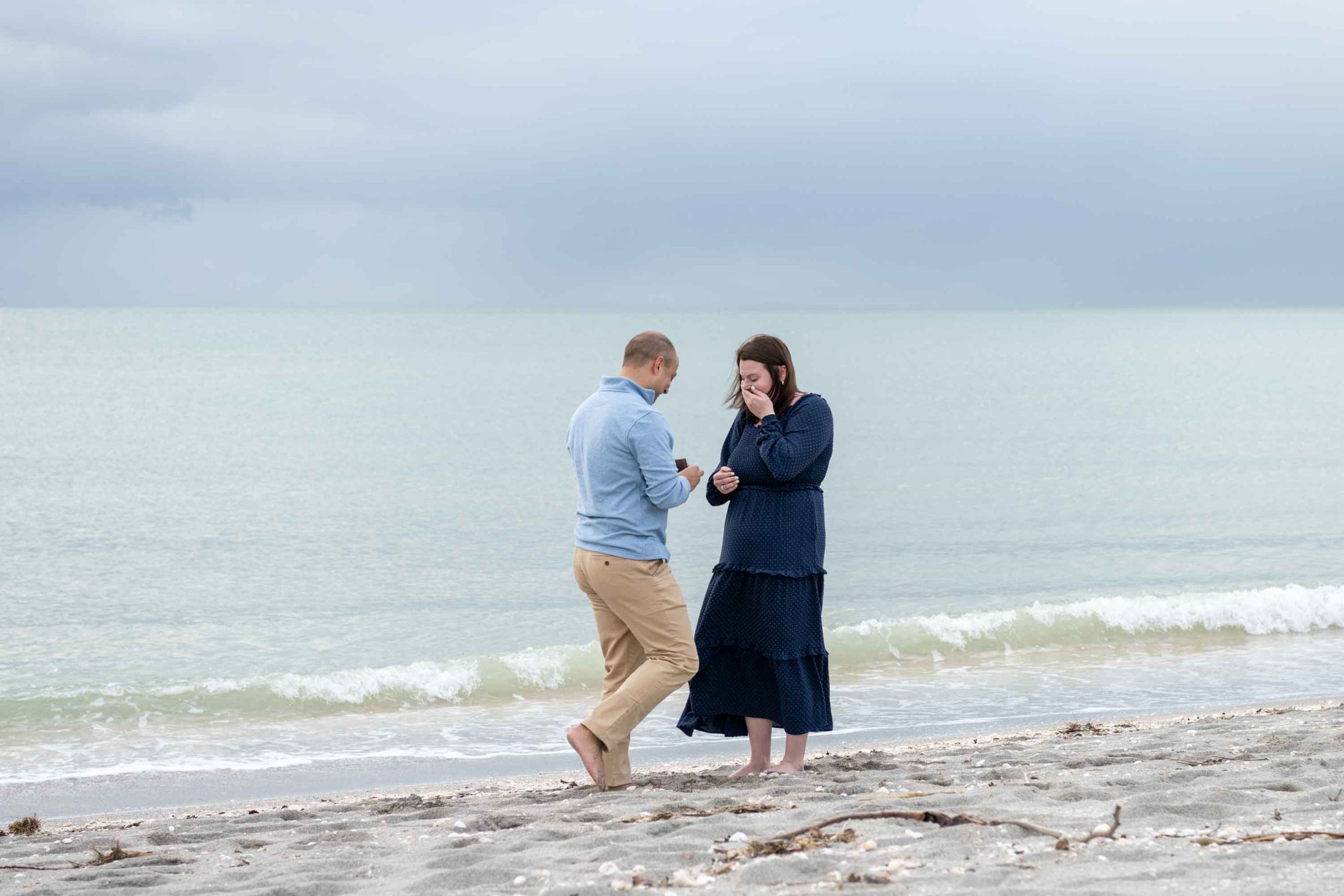 girl covers her mouth in surprise at proposal on Venice Beach