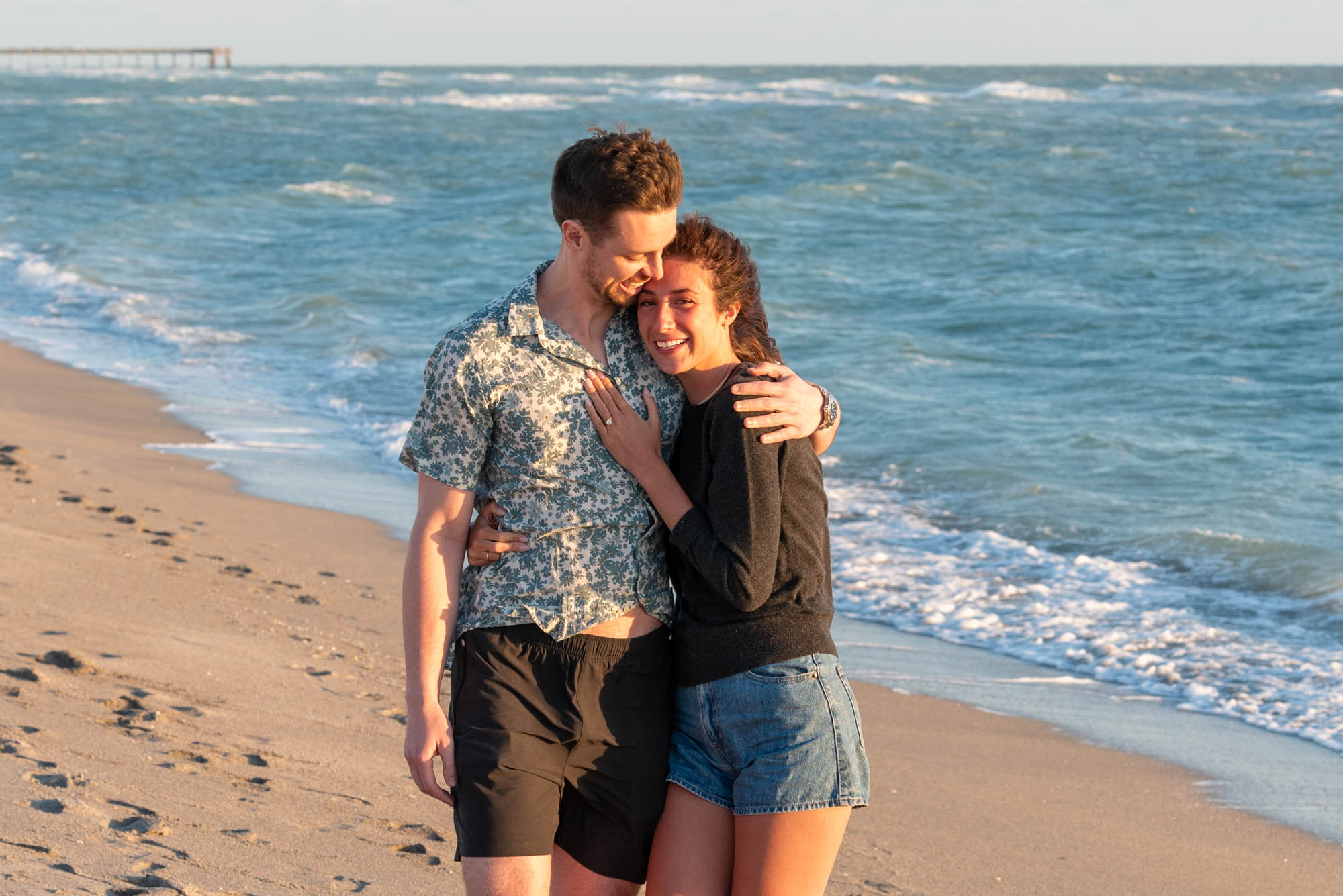 couple hug after surprise proposal on Venice Beach