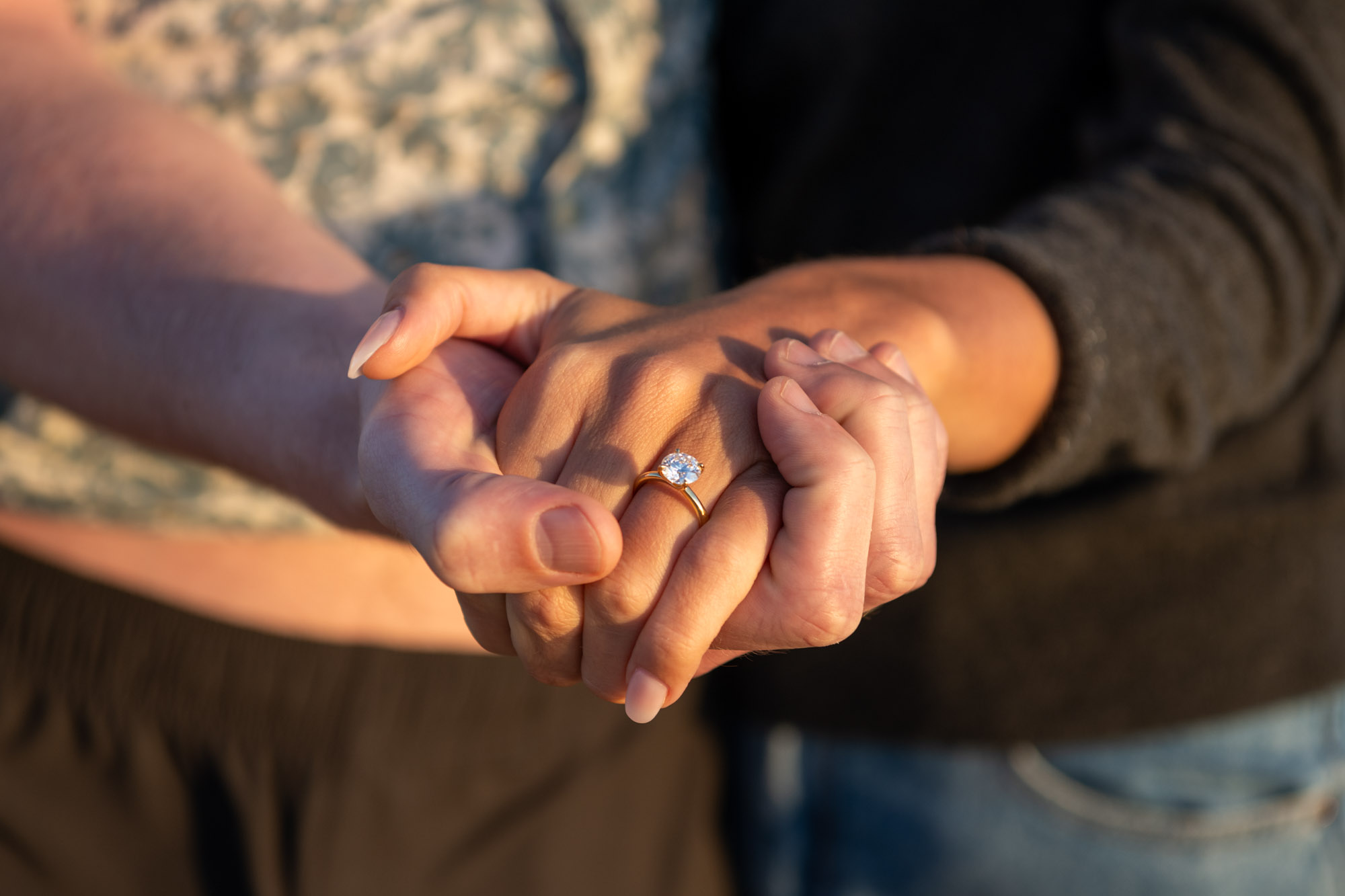 couple show off engagement ring