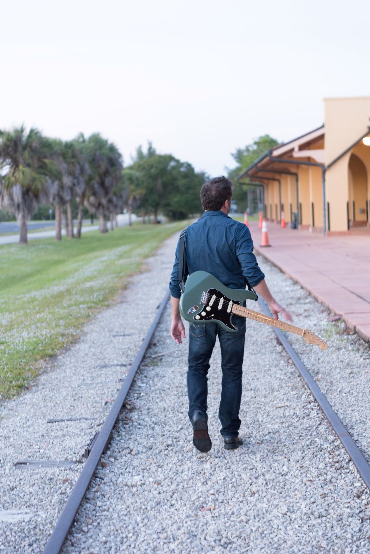 Steve walking away with his guitar slung over his shoulder