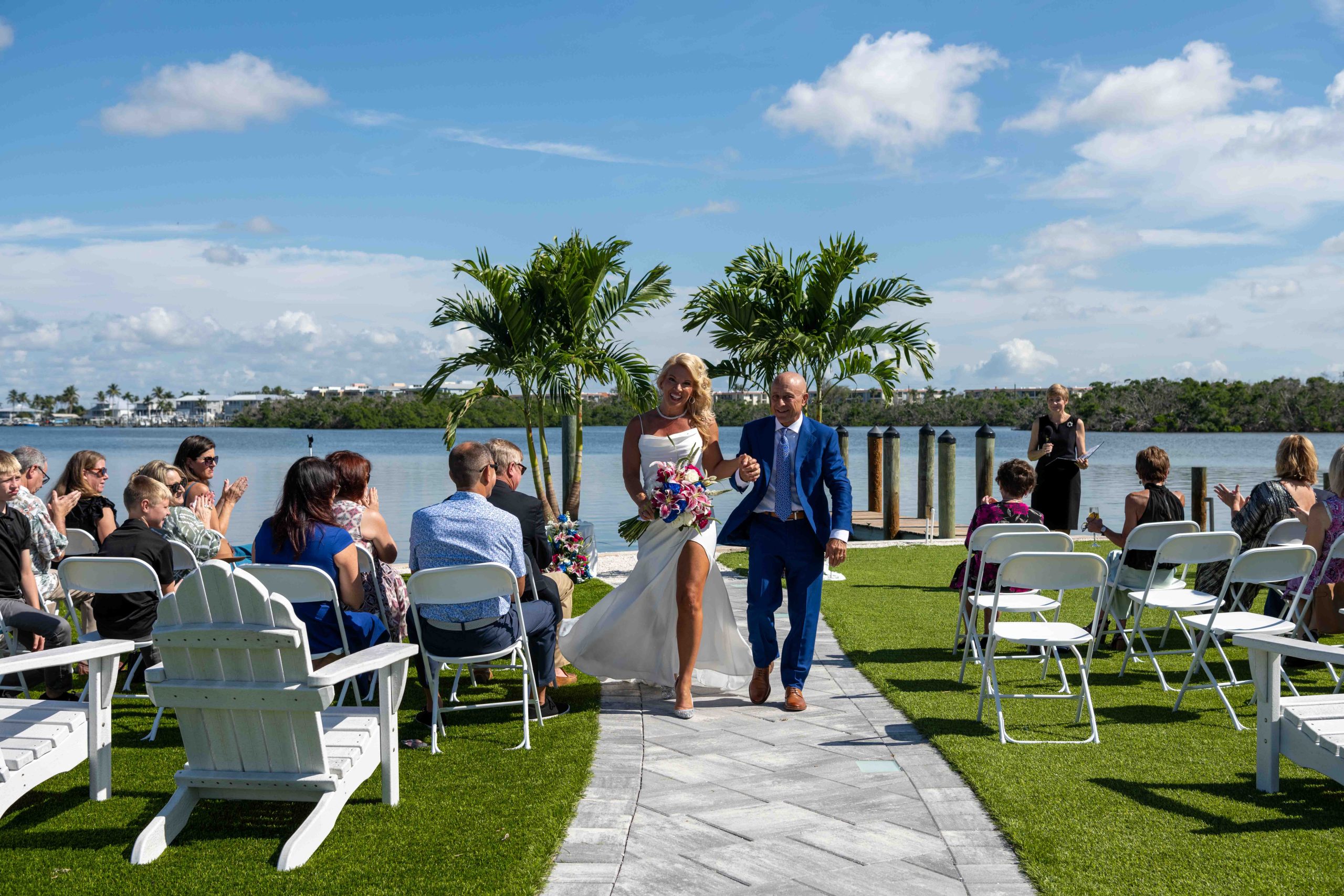 bride and groom walk back down the aisle after wedding ceremony at Magnolias on the Bay