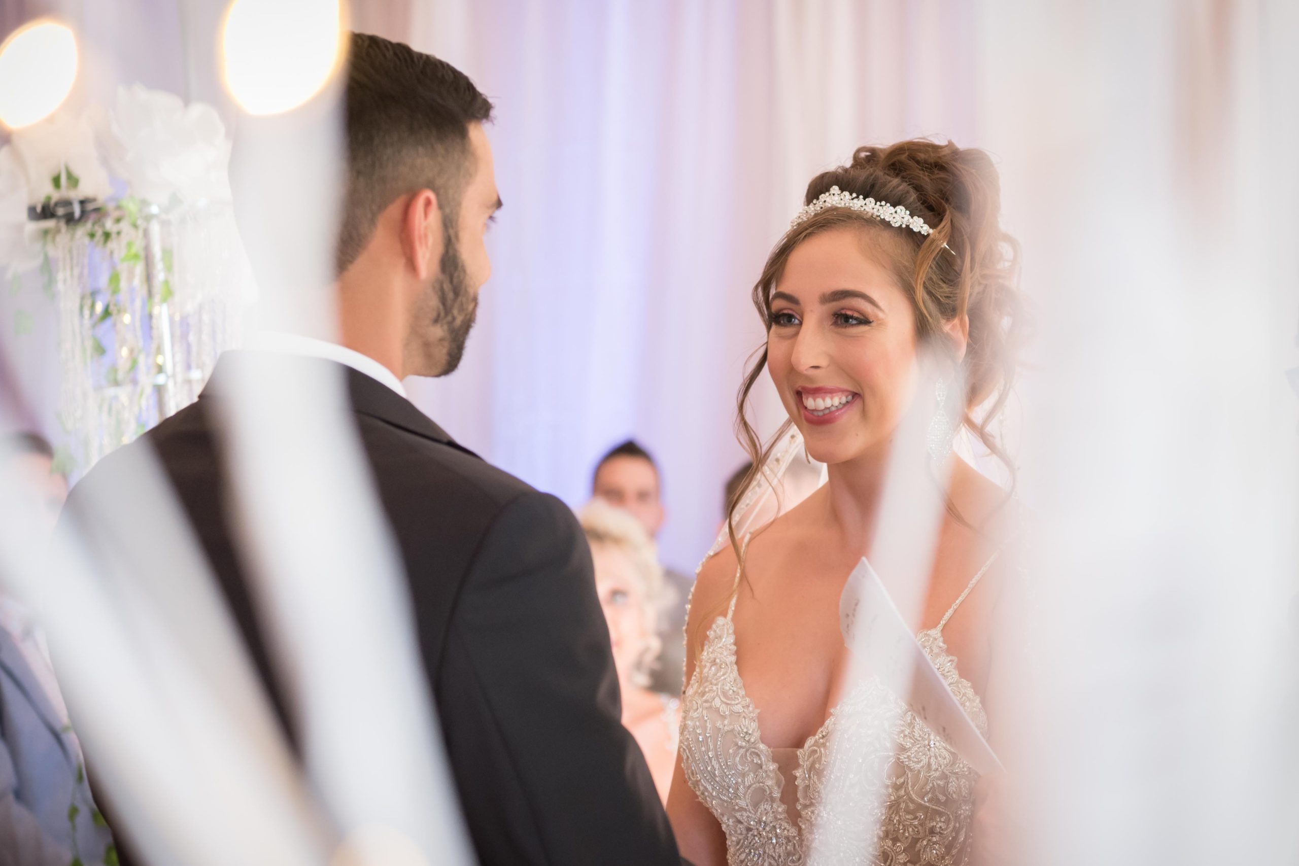bride looks lovingly at her husband during their wedding ceremony