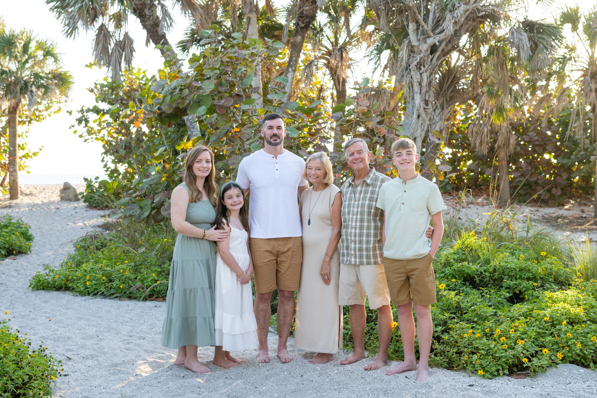 family together at Blind Pass Beach amongst the trees