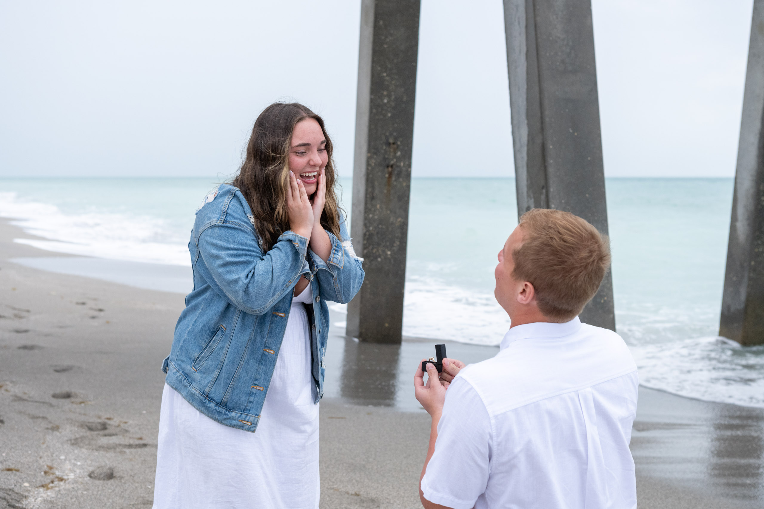 girlfriend reacts in happy shock to her boyfriend proposing on his knee