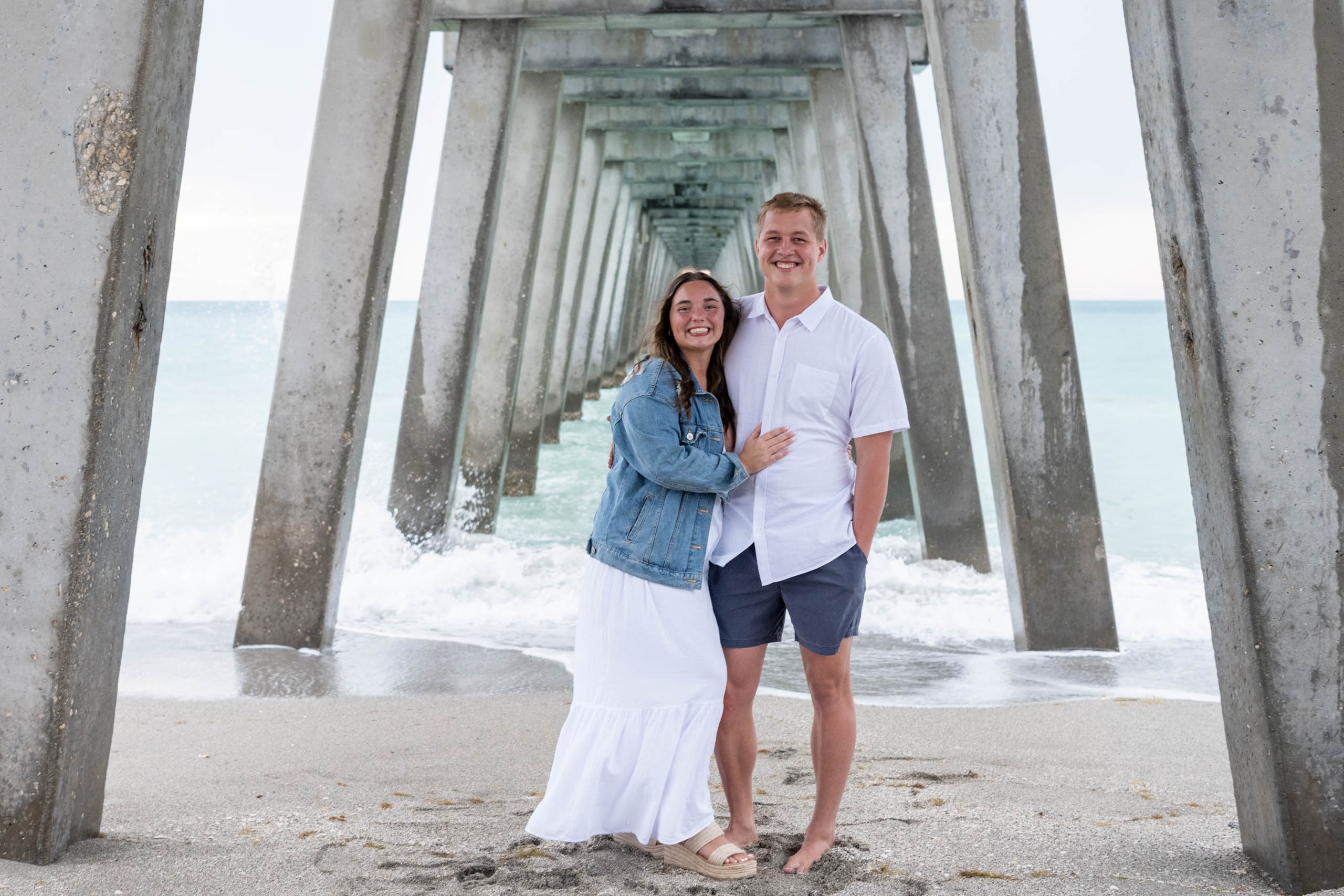 newly engaged couple under the Venice Pier