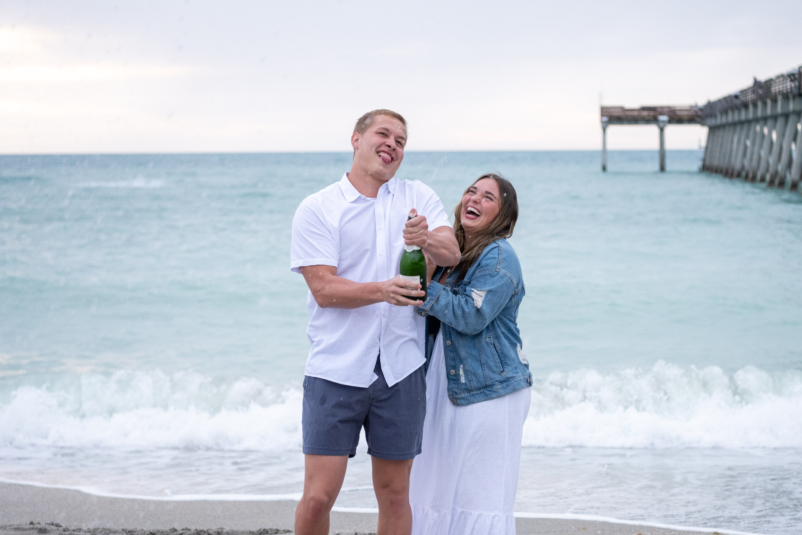 couple spray champagne and celebrate