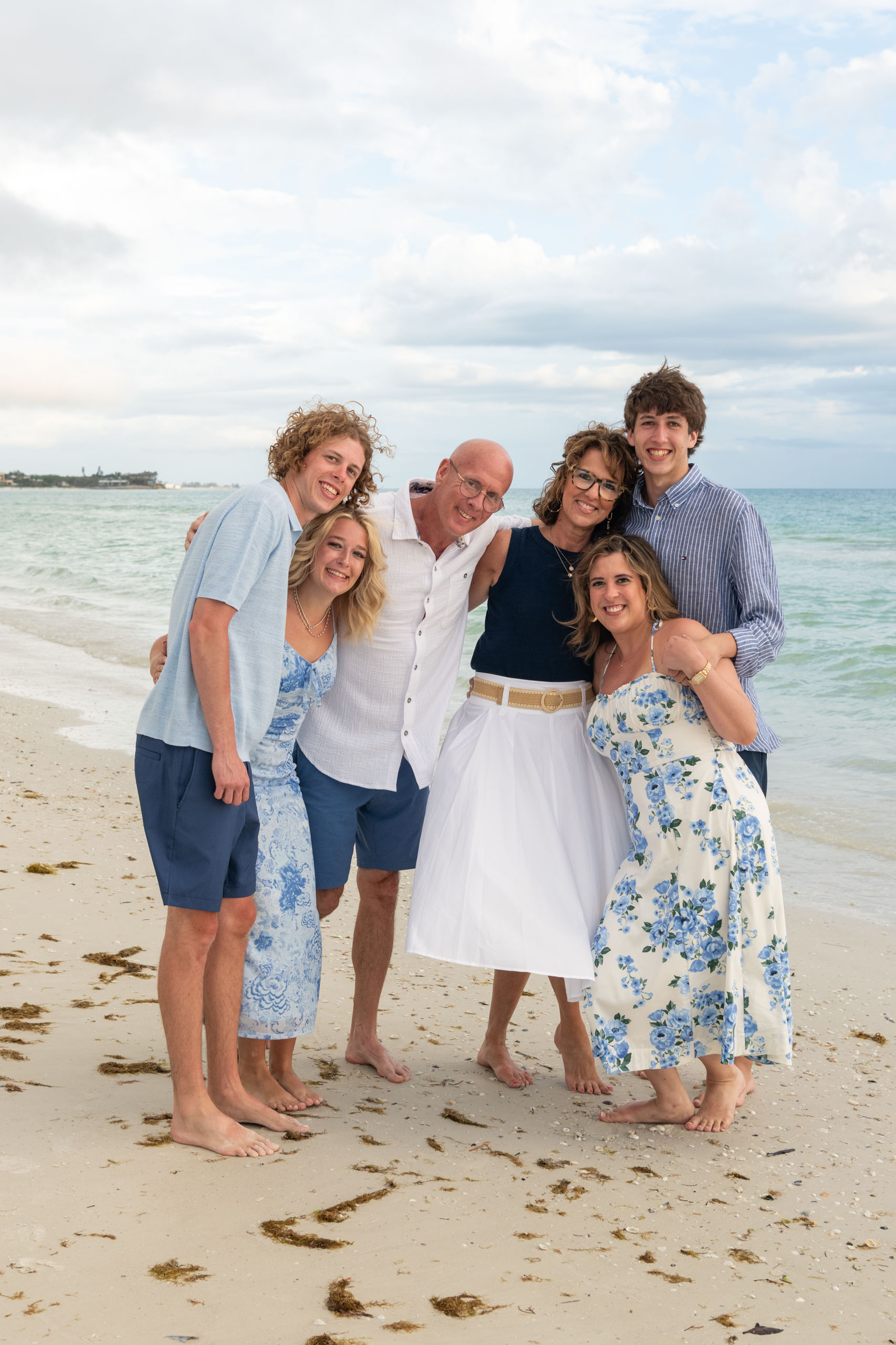 parents with their adult children on the beach