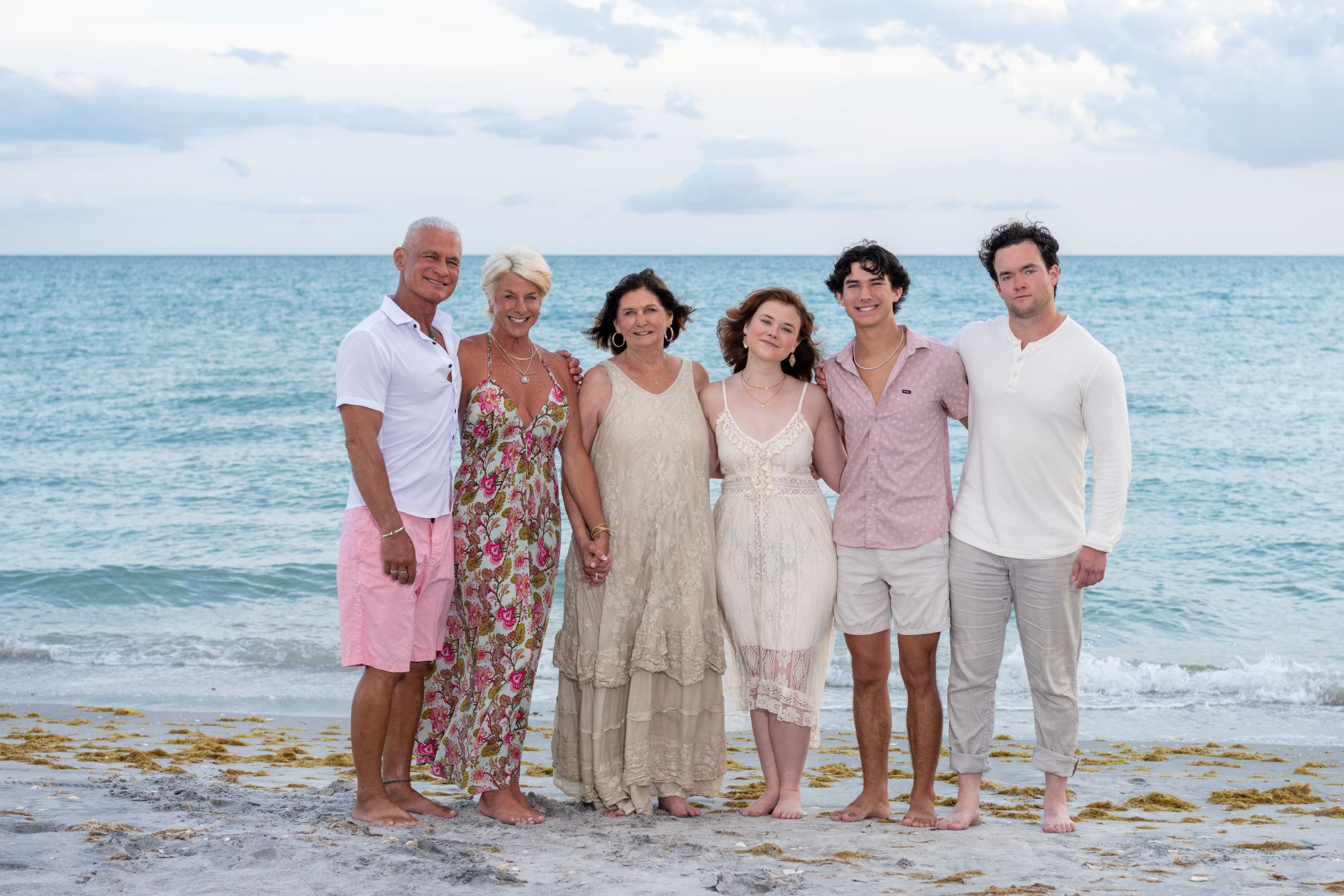 family on the beach dressed in pink accents