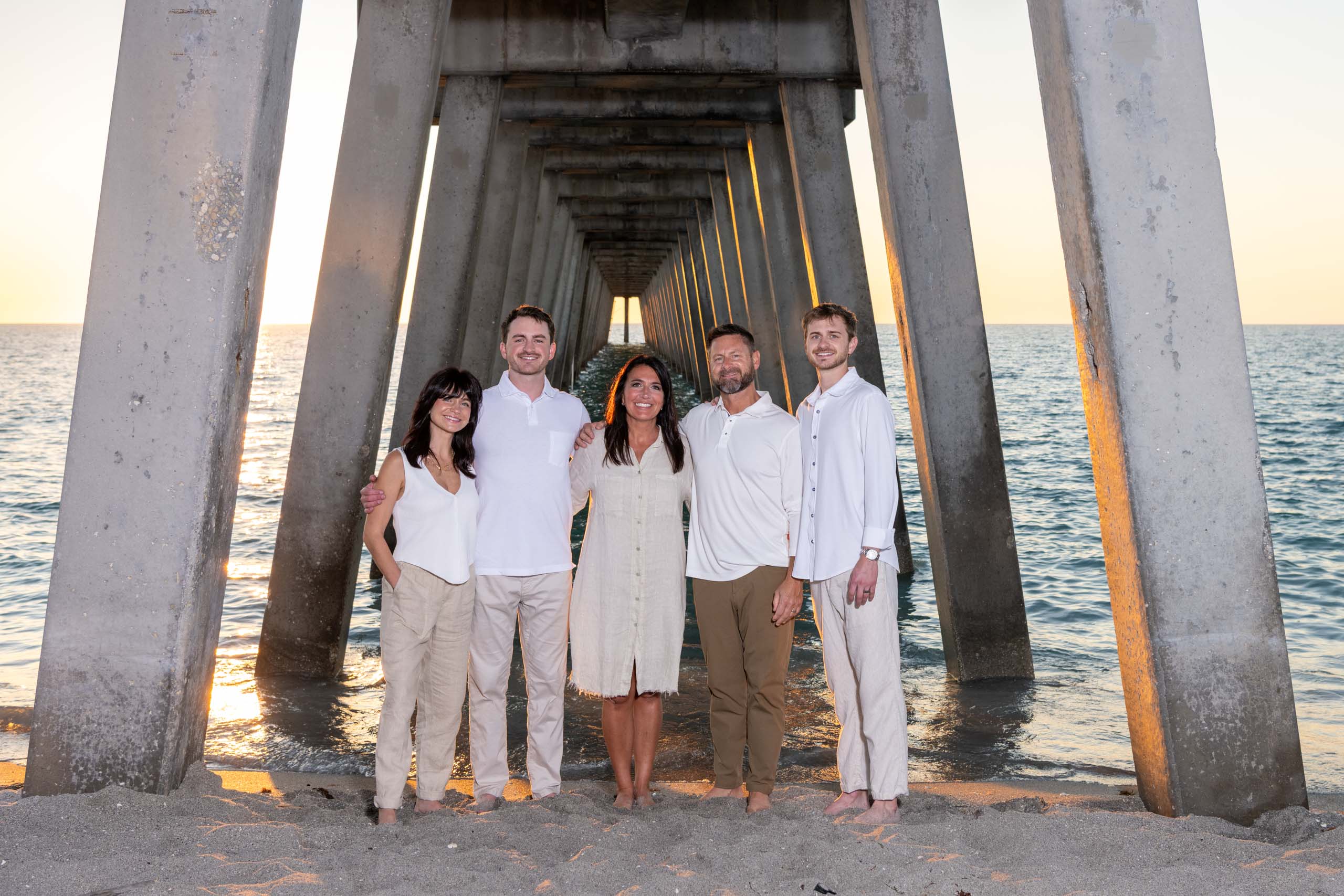 parents with their adult children under the pier