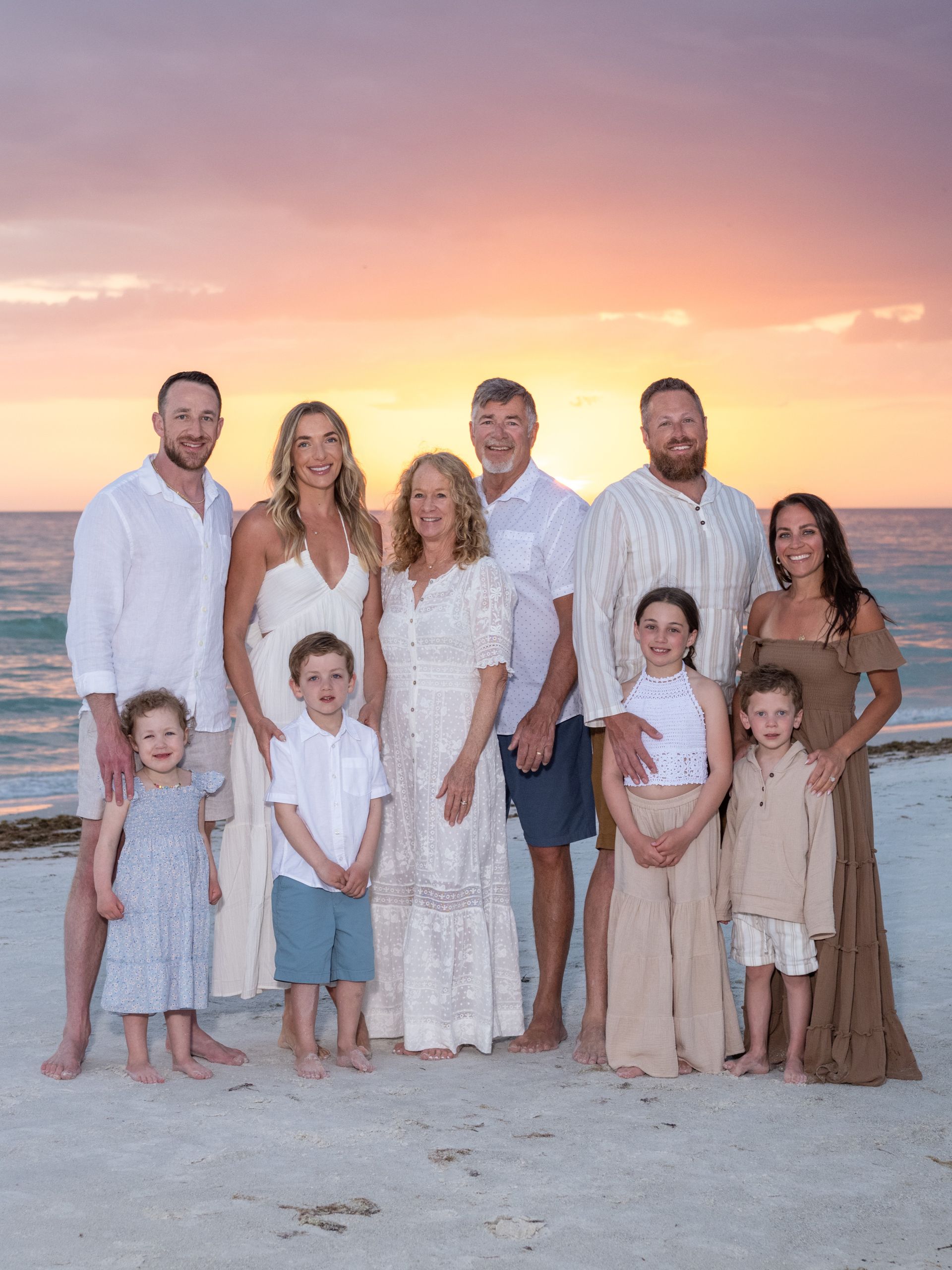family with gorgeous sunset behind them