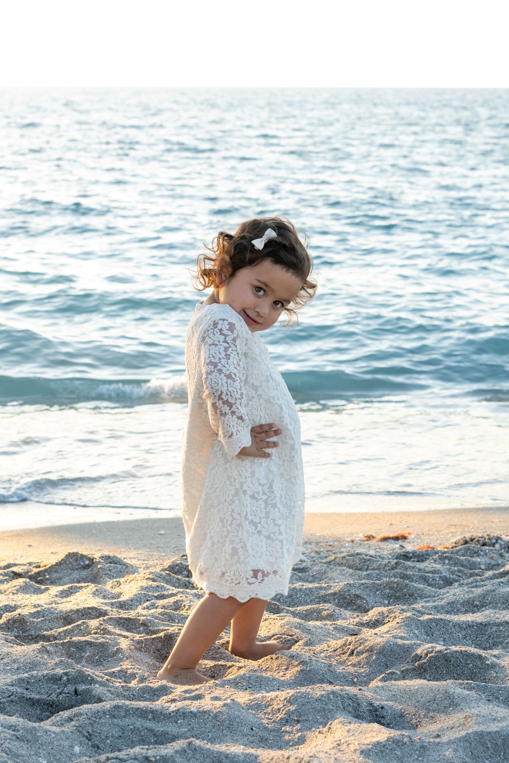 cute little girl posing by the water