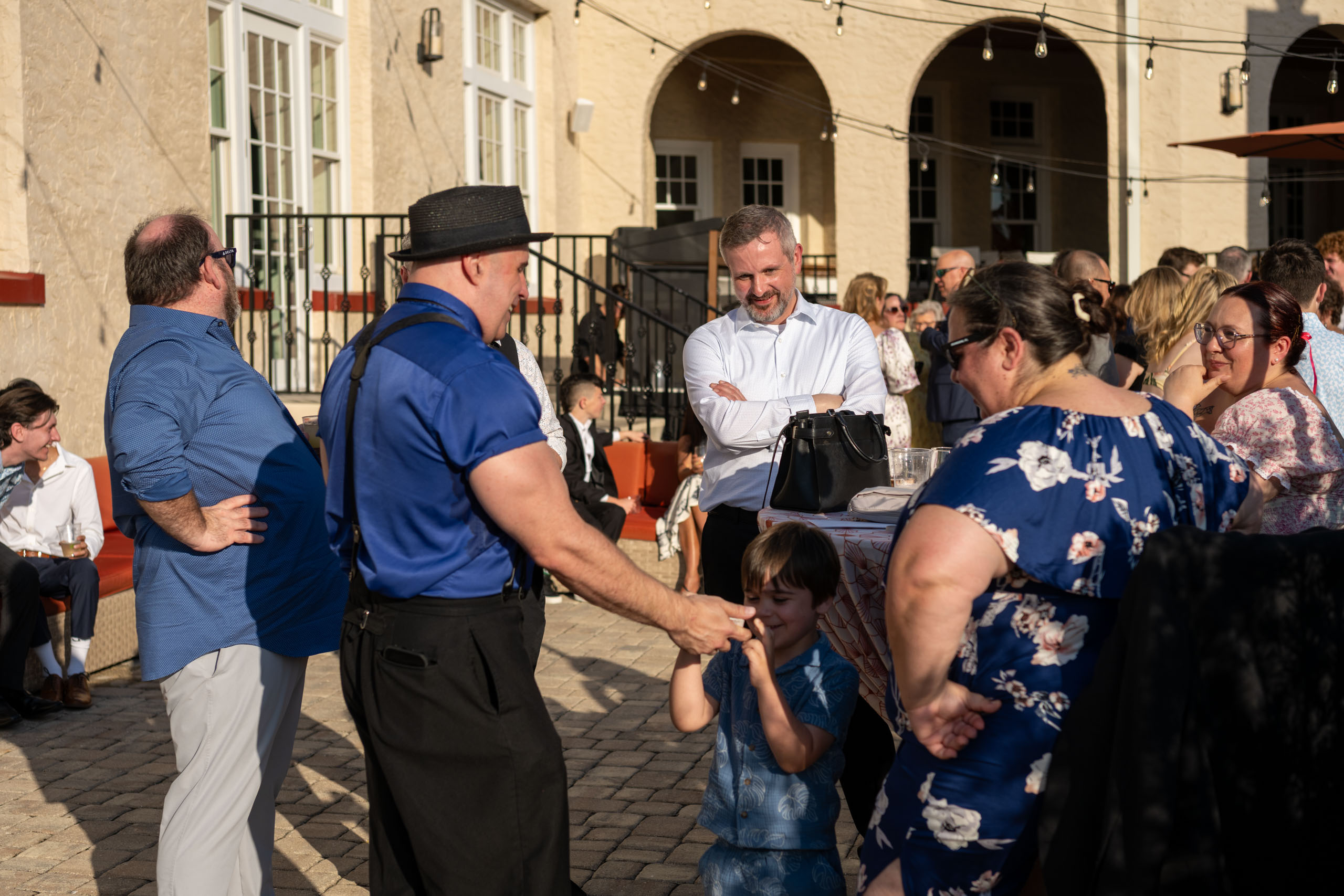 guests enjoying magician's illusions during cocktail hour at the Fenway Hotel Dunedin