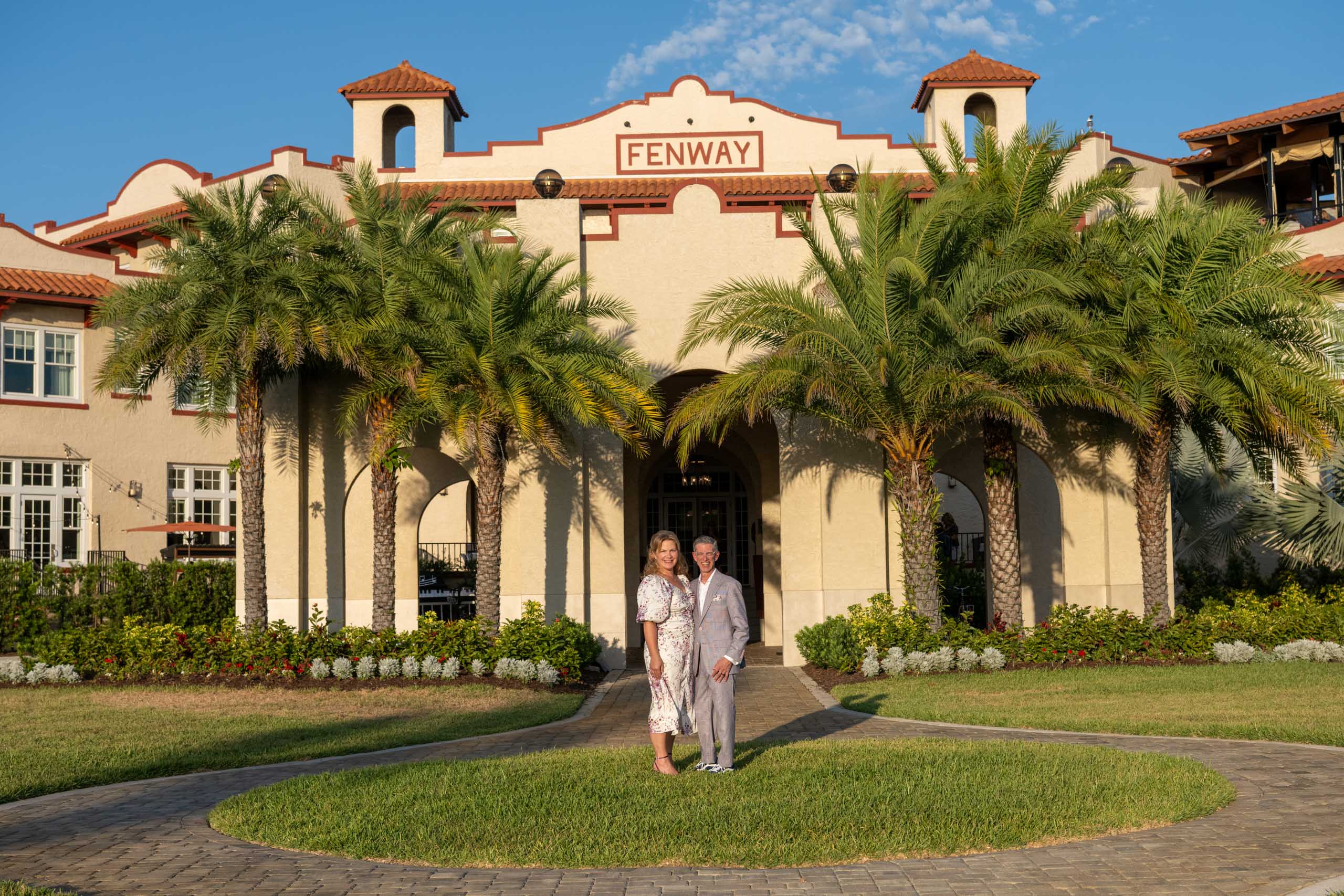 newly married couple stand in front of the Fenway Hotel in Dunedin