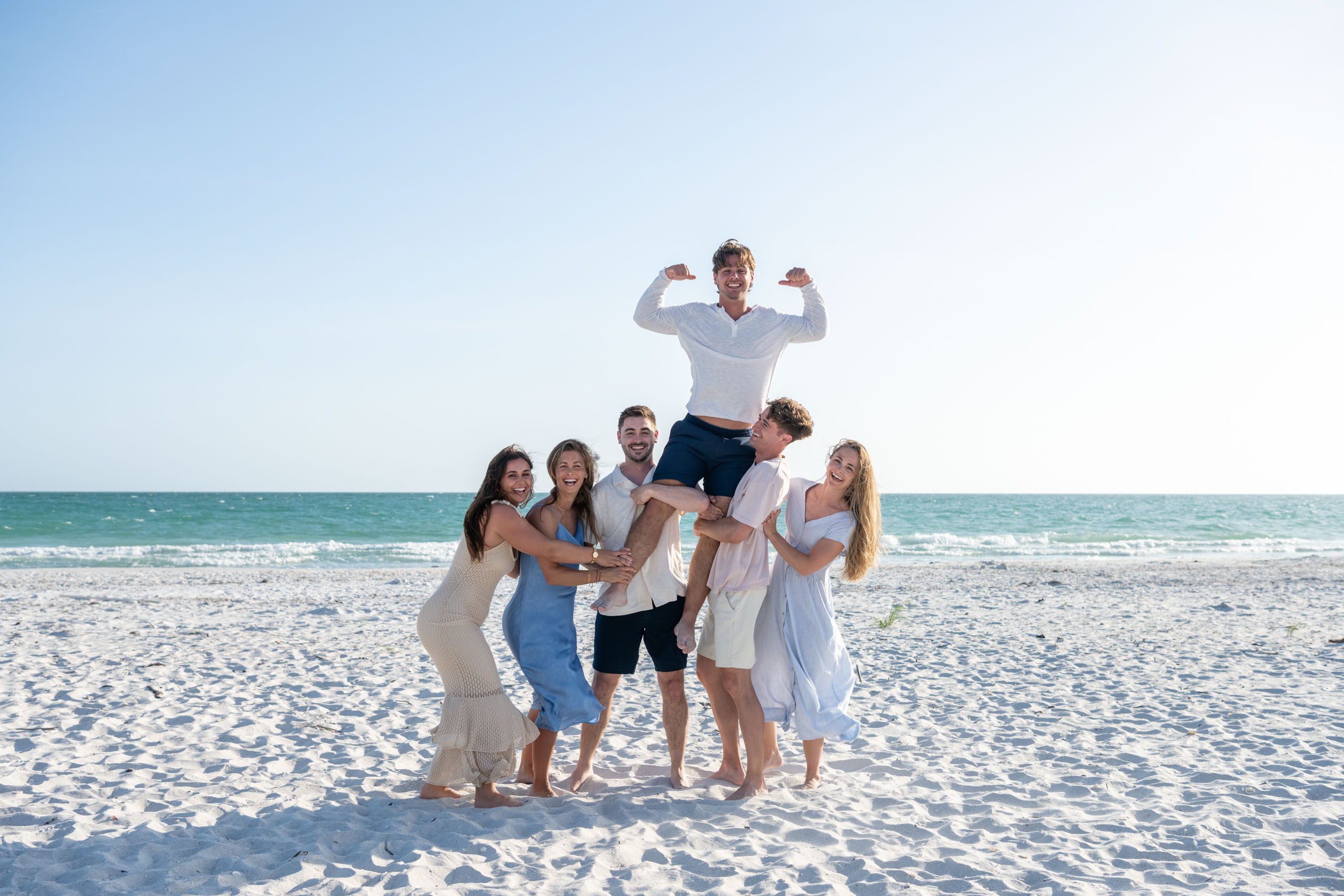 siblings lifting up their brother for fun