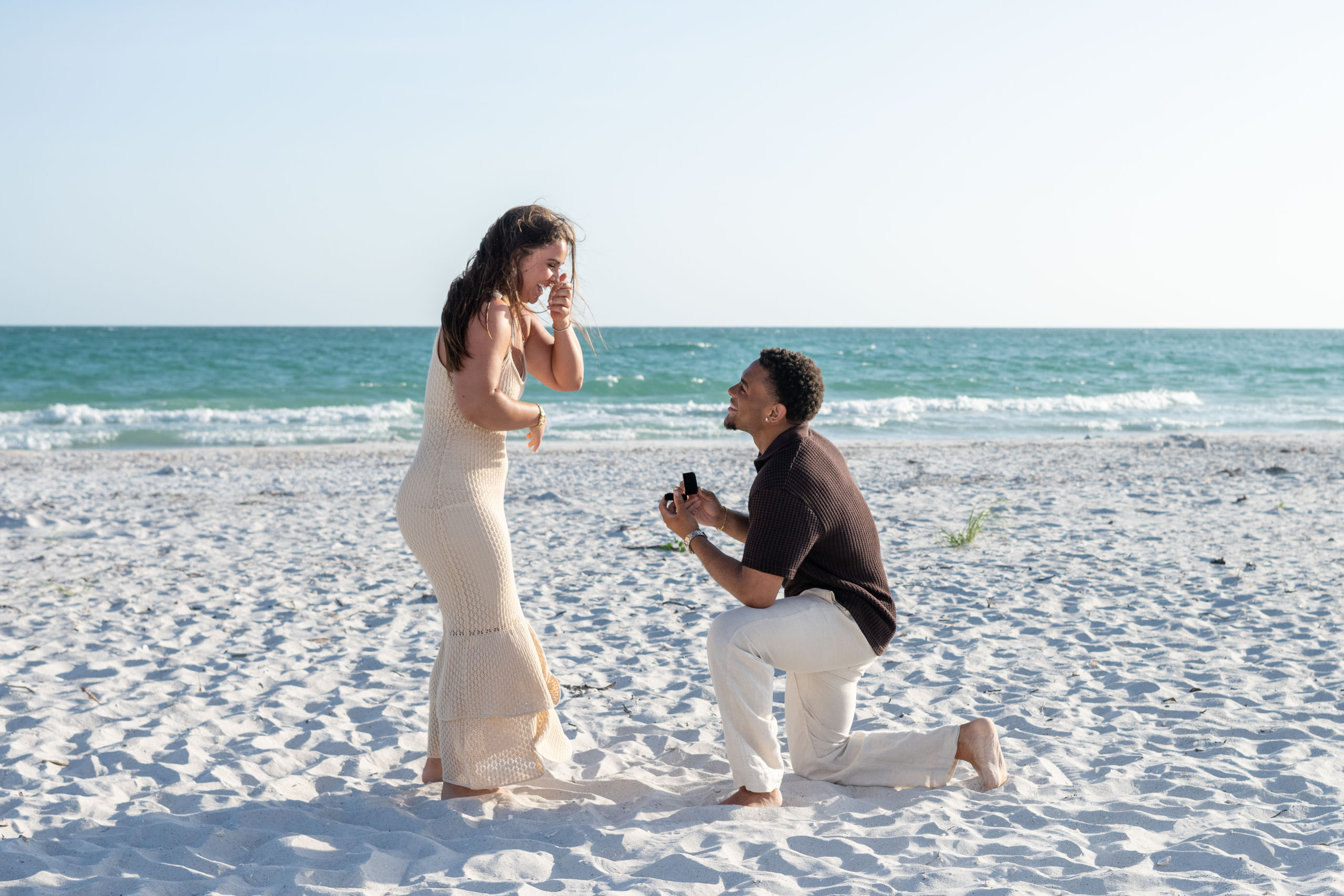 a surprise proposal on the beach