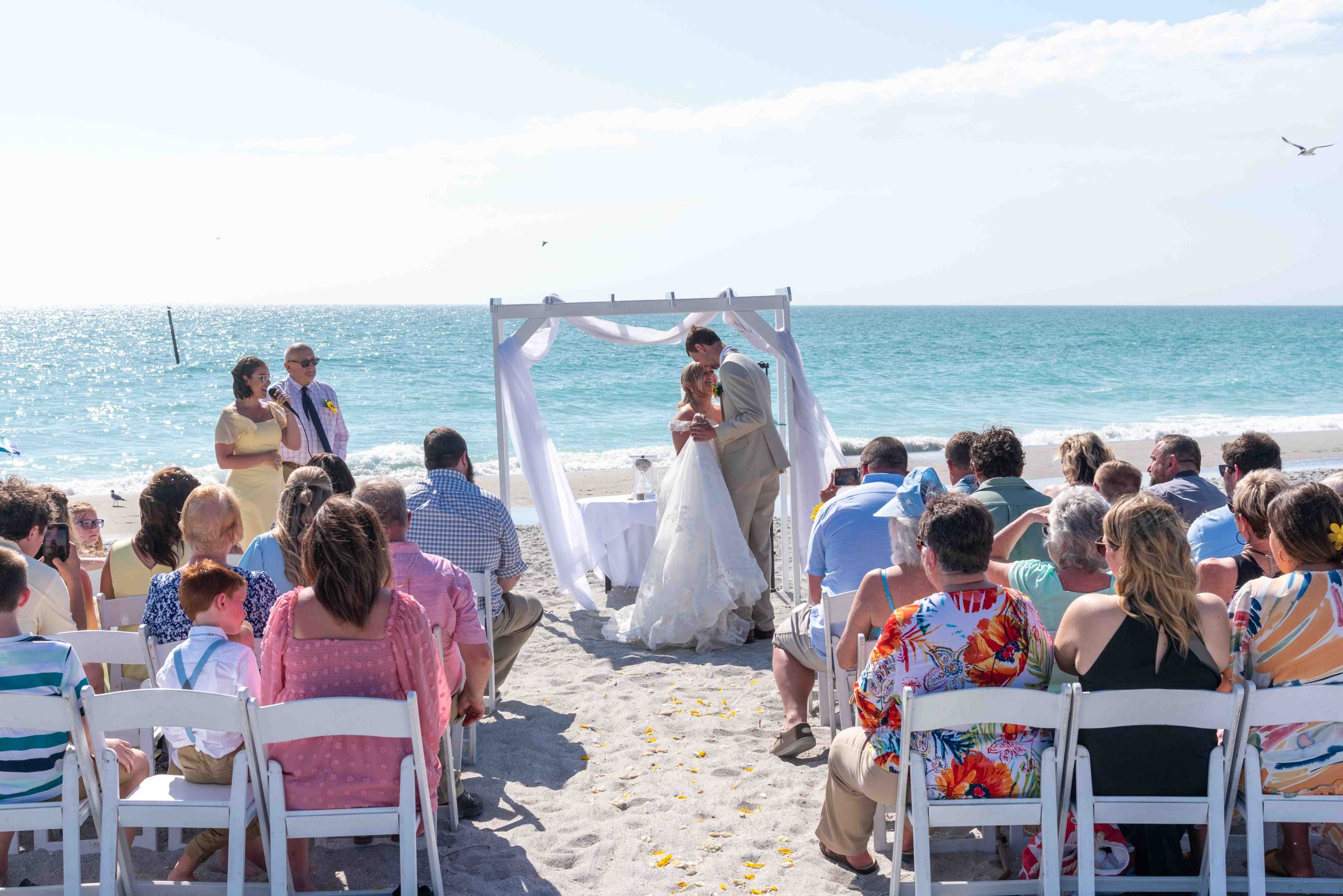 afternoon beach wedding with bride and groom dancing