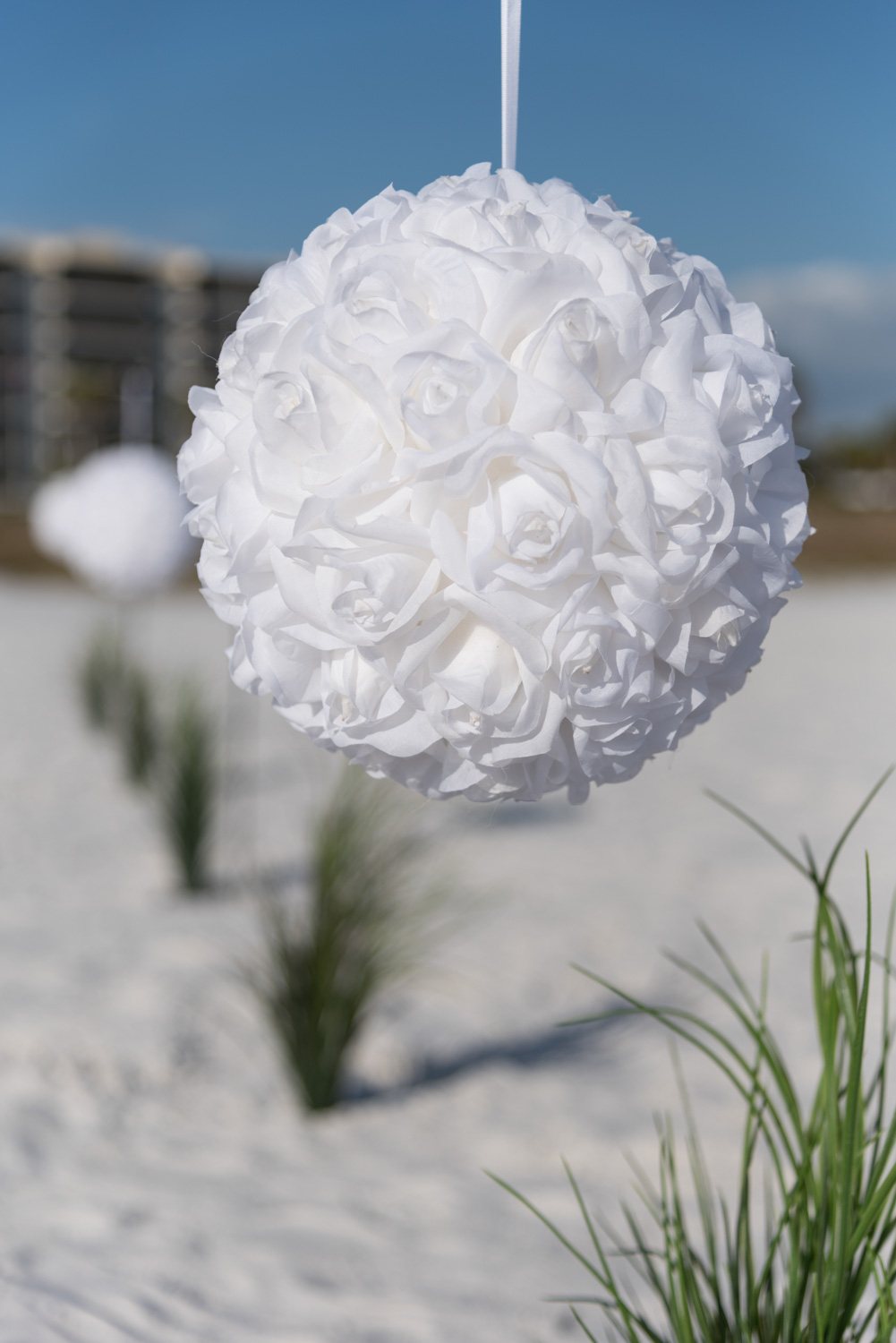 a white rose flower ball lines the beach