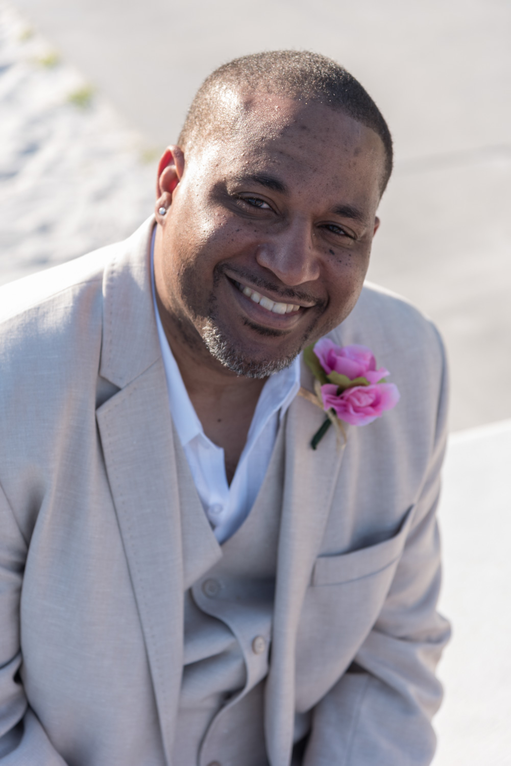 groom smiles as he looks up before his wedding