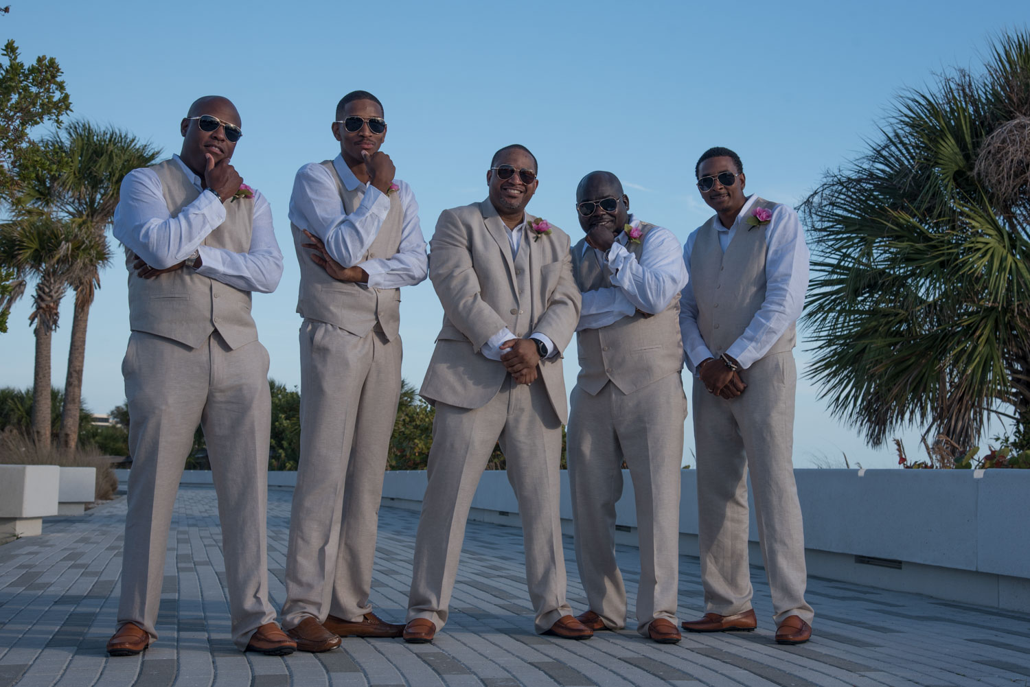 groomsmen strike a pose on the boardwalk at Siesta Key before beach wedding