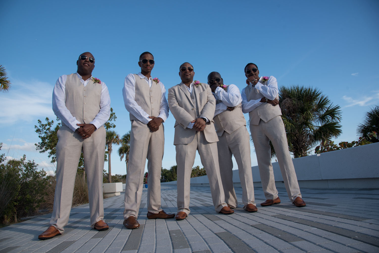 groomsmen pose on the boardwalk at Siesta Key Beach before wedding