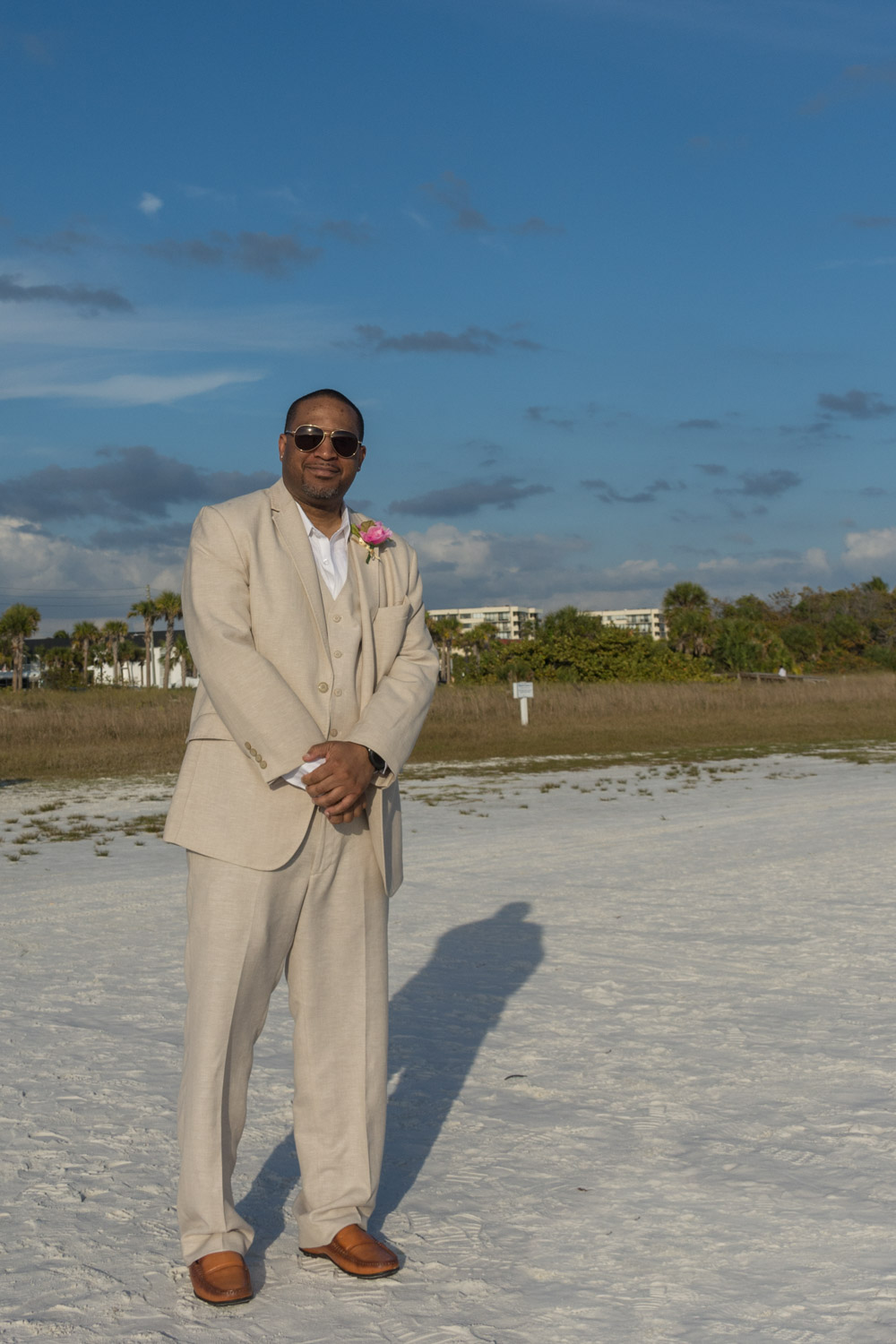 groom walks down the beach on his way to the altar