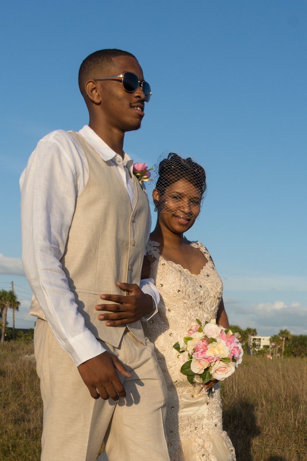 bride smiles as she walks to the arch