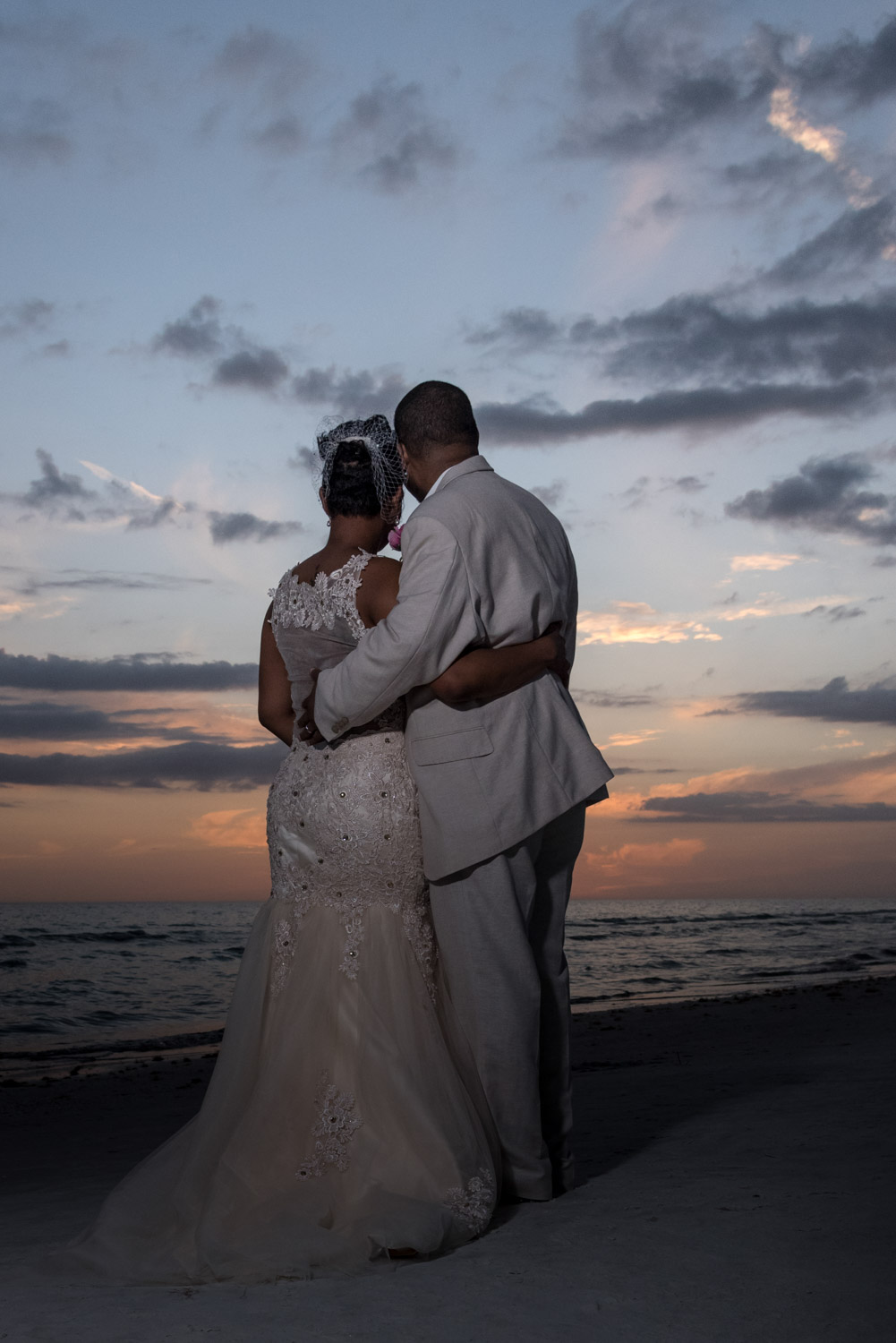 bride and groom watch the sunset