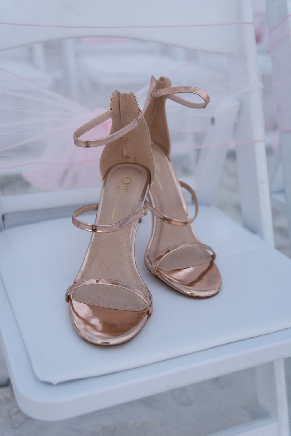 bride's copper high heeled shoes on a wedding chair