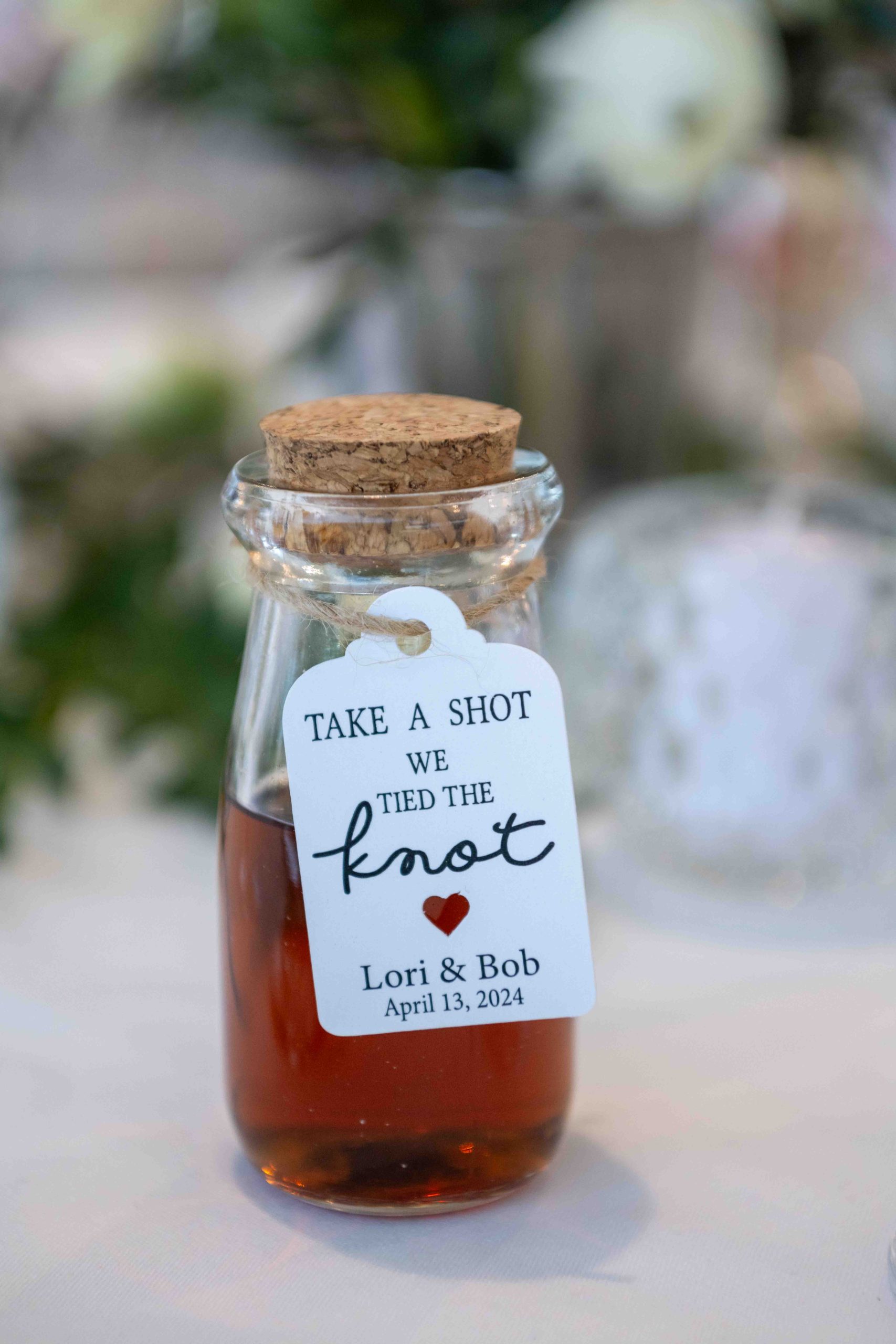 custom shots on the table with a cute sign that reads, "take a shot, we tied the knot"
